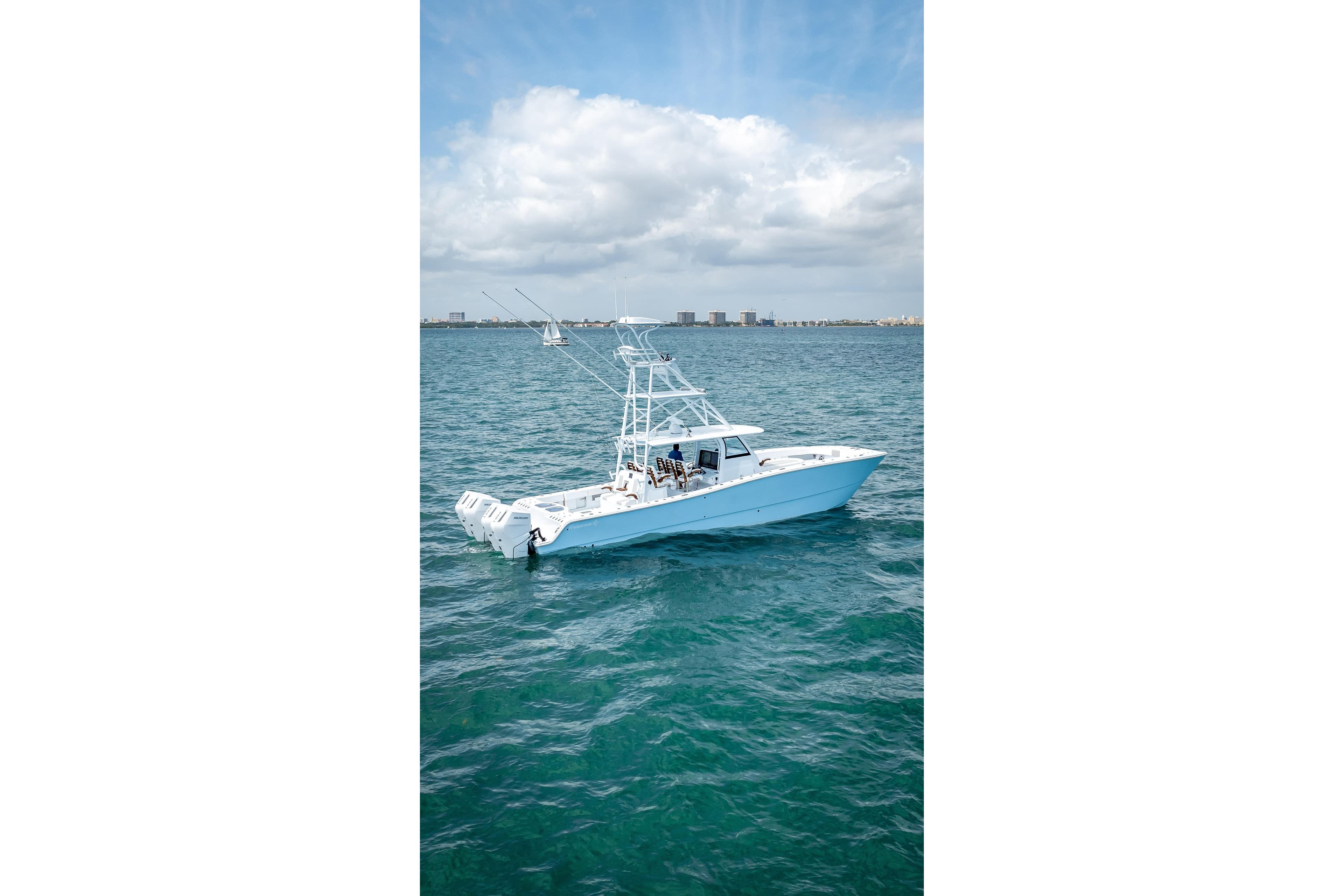 2025 Freeman 43 boat cruising on open water under a partly cloudy sky.