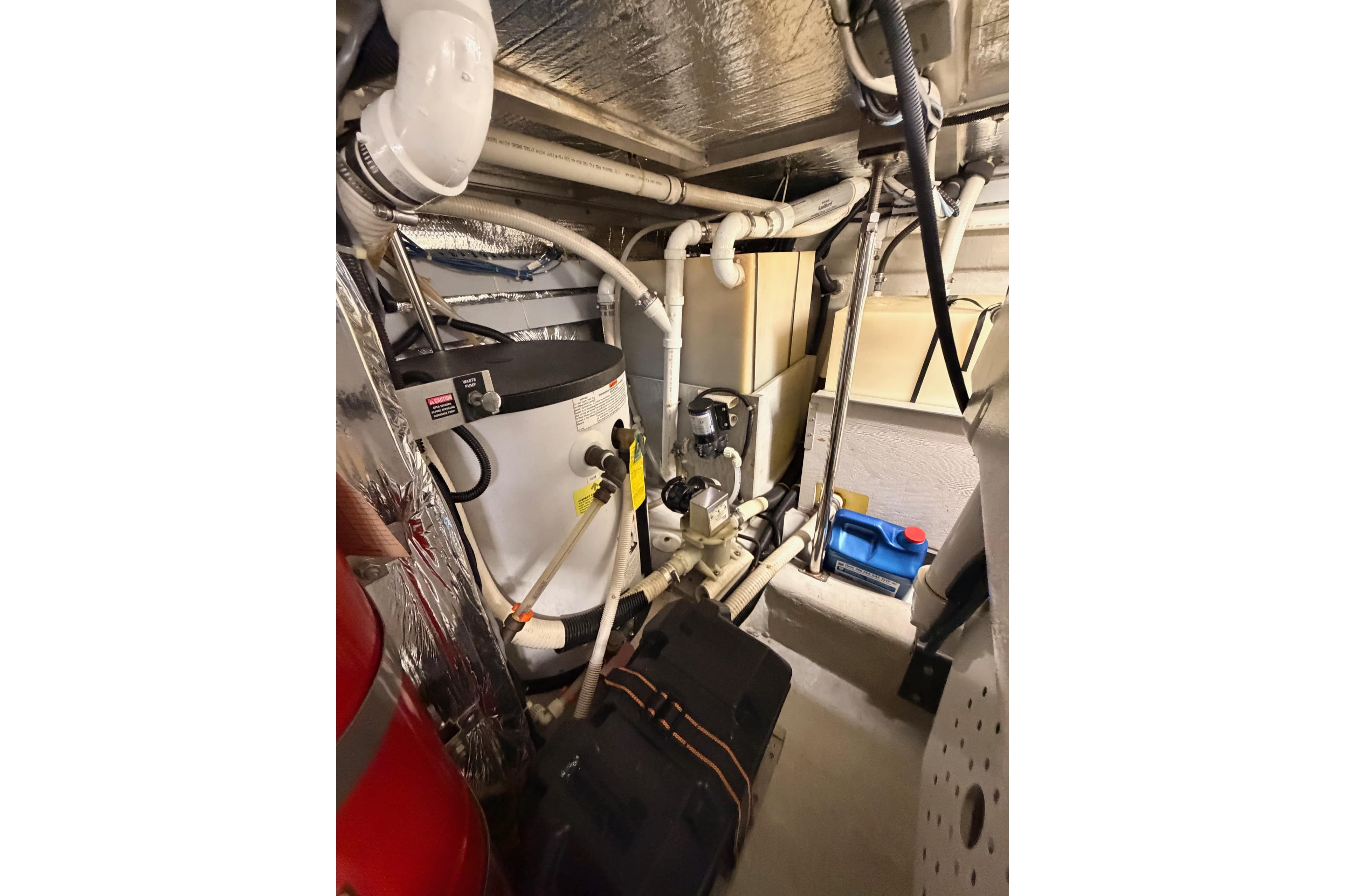 Engine room of 1999 Carver 530 Voyager Pilothouse with mechanical equipment and piping.