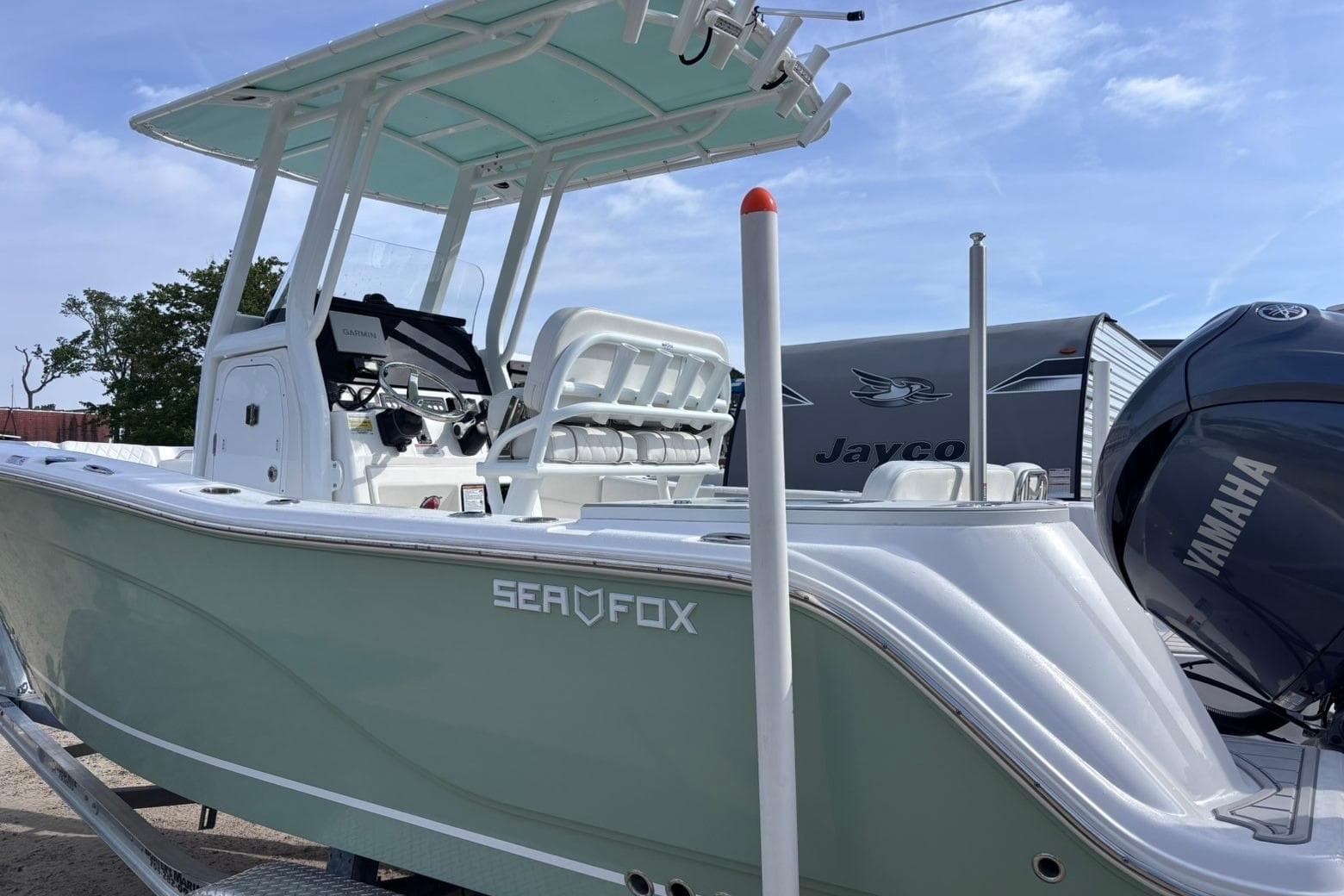 2025 Sea Fox 228 Commander boat with Yamaha engine, parked outdoors.