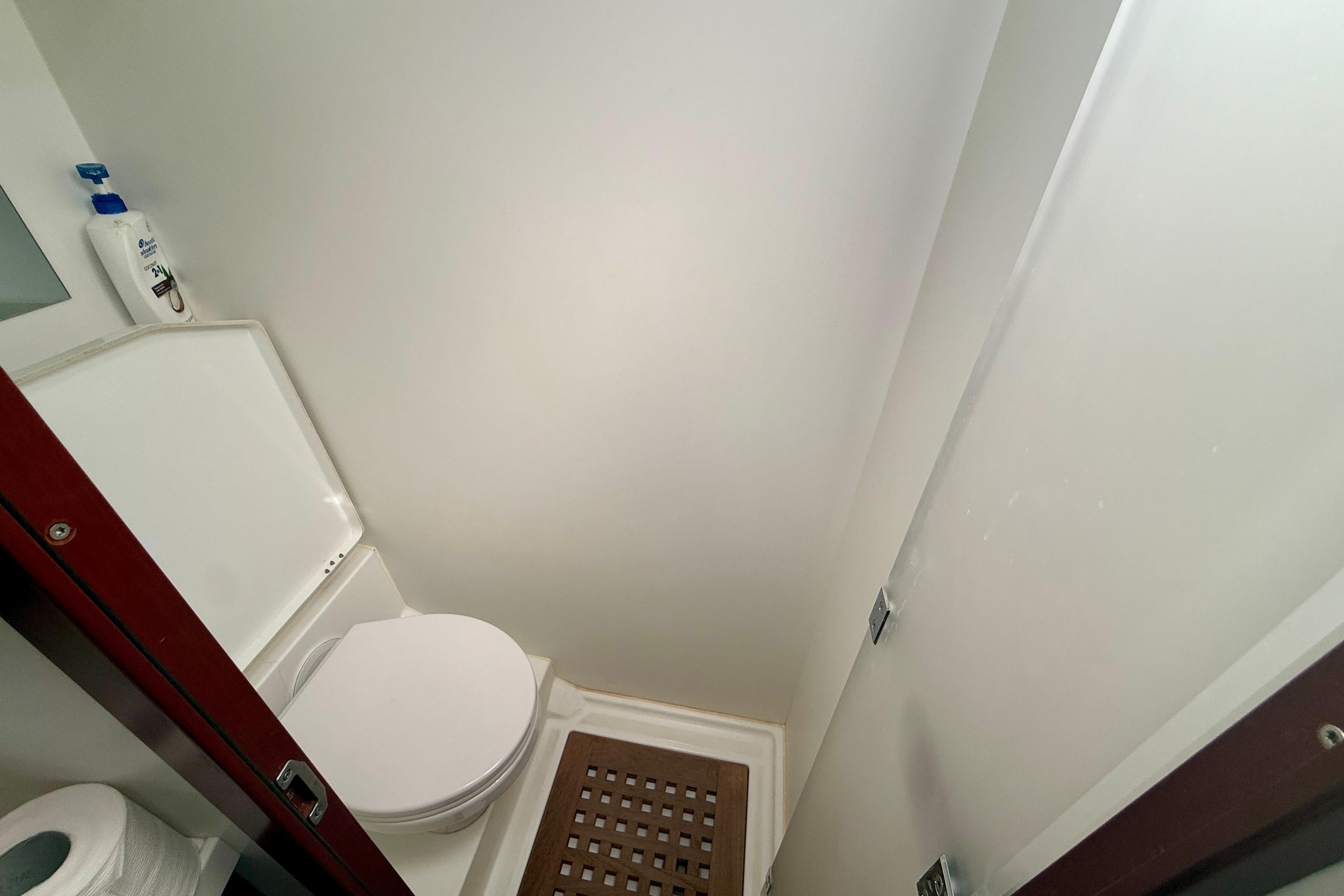Bathroom interior of 2020 Beneteau Swift Trawler 44, featuring toilet and shower area.