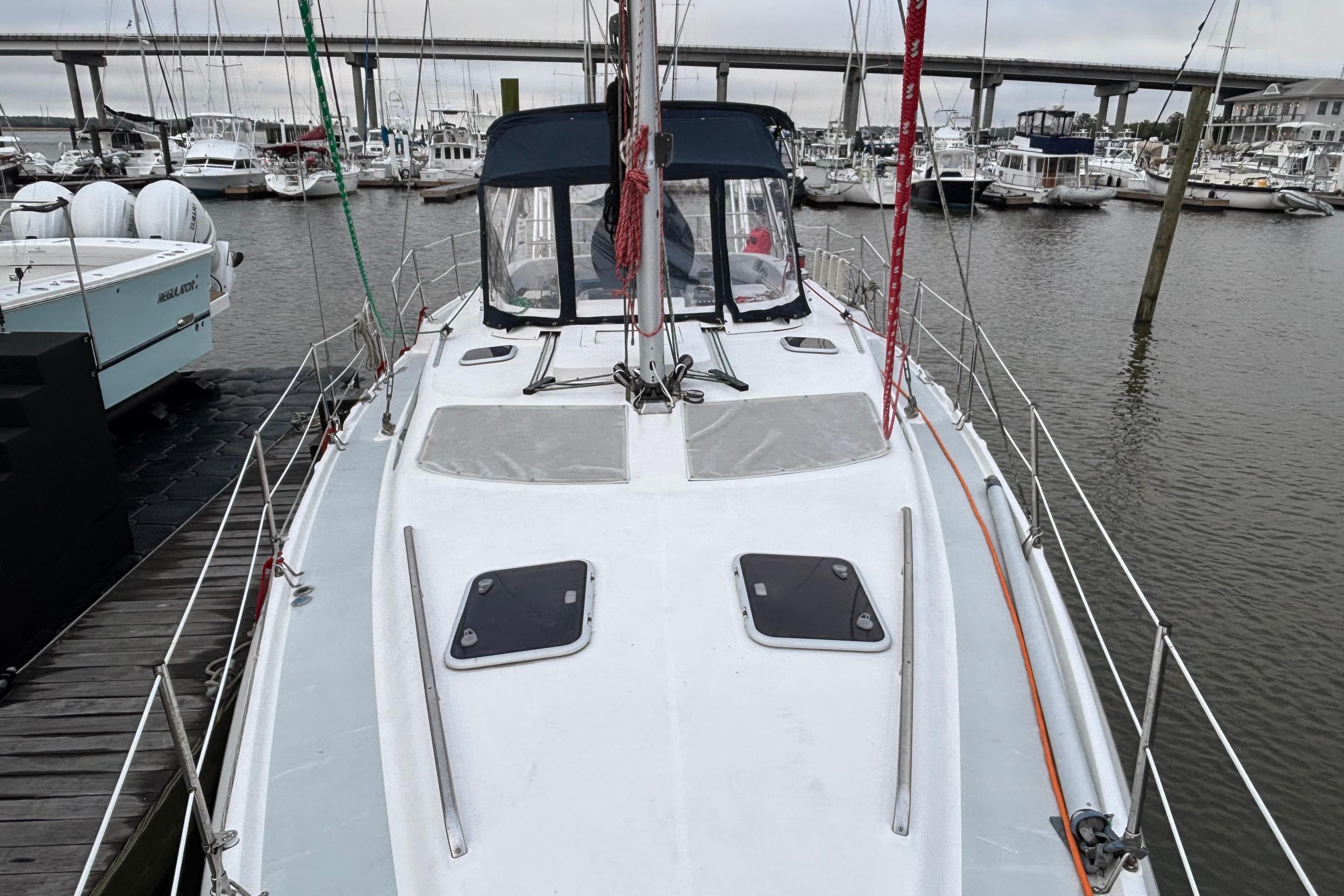 Hunter Passage 450 sailboat docked at marina, showcasing deck and cabin, year 2000 model.