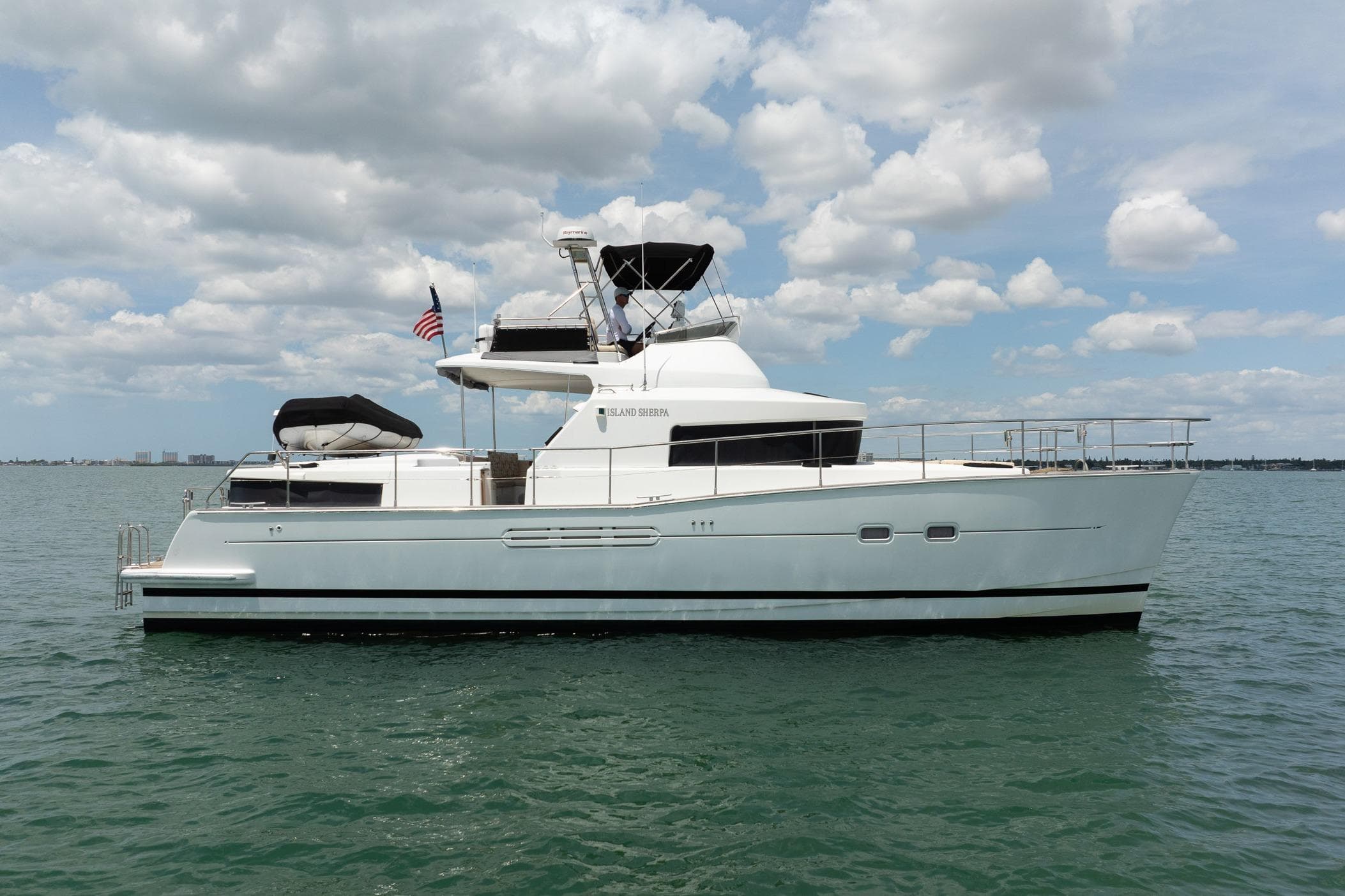 2005 Lagoon Power 43 yacht on calm water under a partly cloudy sky.