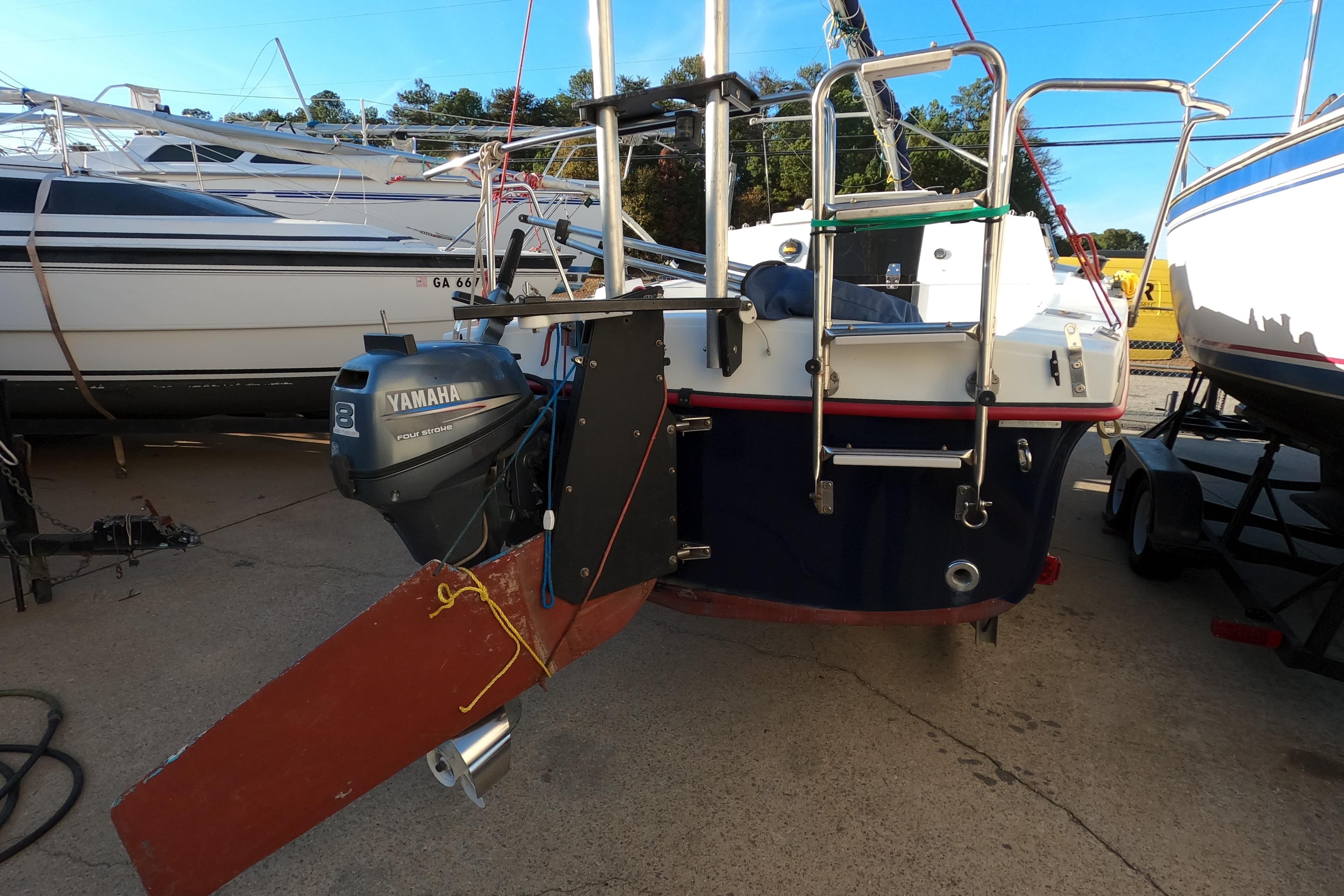 1996 Rhodes 22 sailboat with Yamaha outboard motor, docked in a marina.