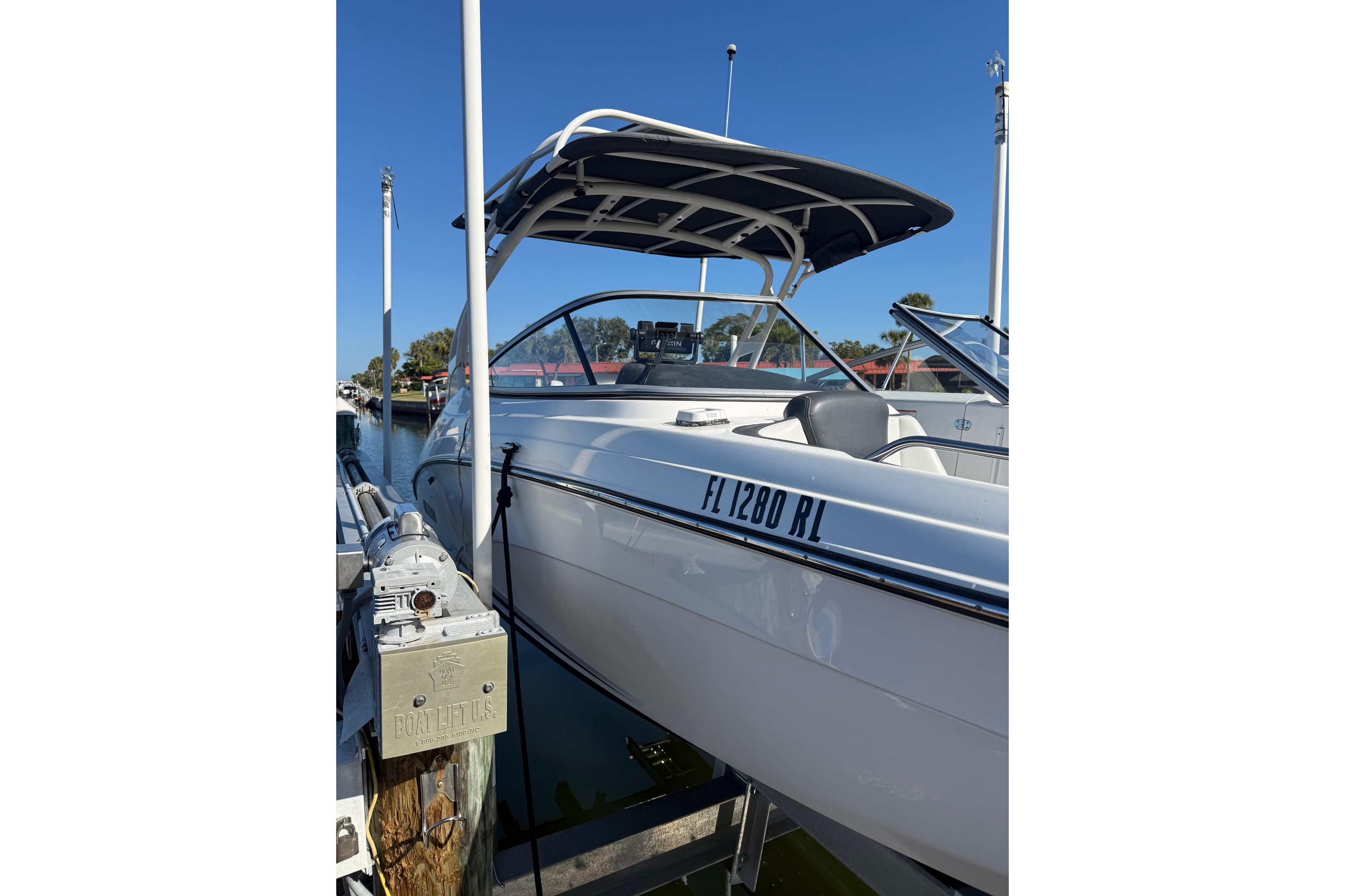 2017 Yamaha Boats 242 Limited S E-Series docked, featuring sleek design and canopy.