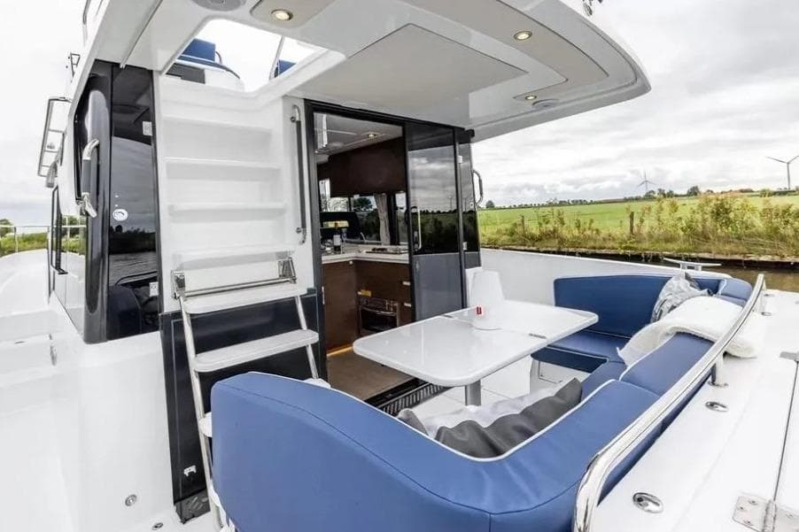2026 Delphia 11 Flylounge yacht with outdoor seating and modern interior design.