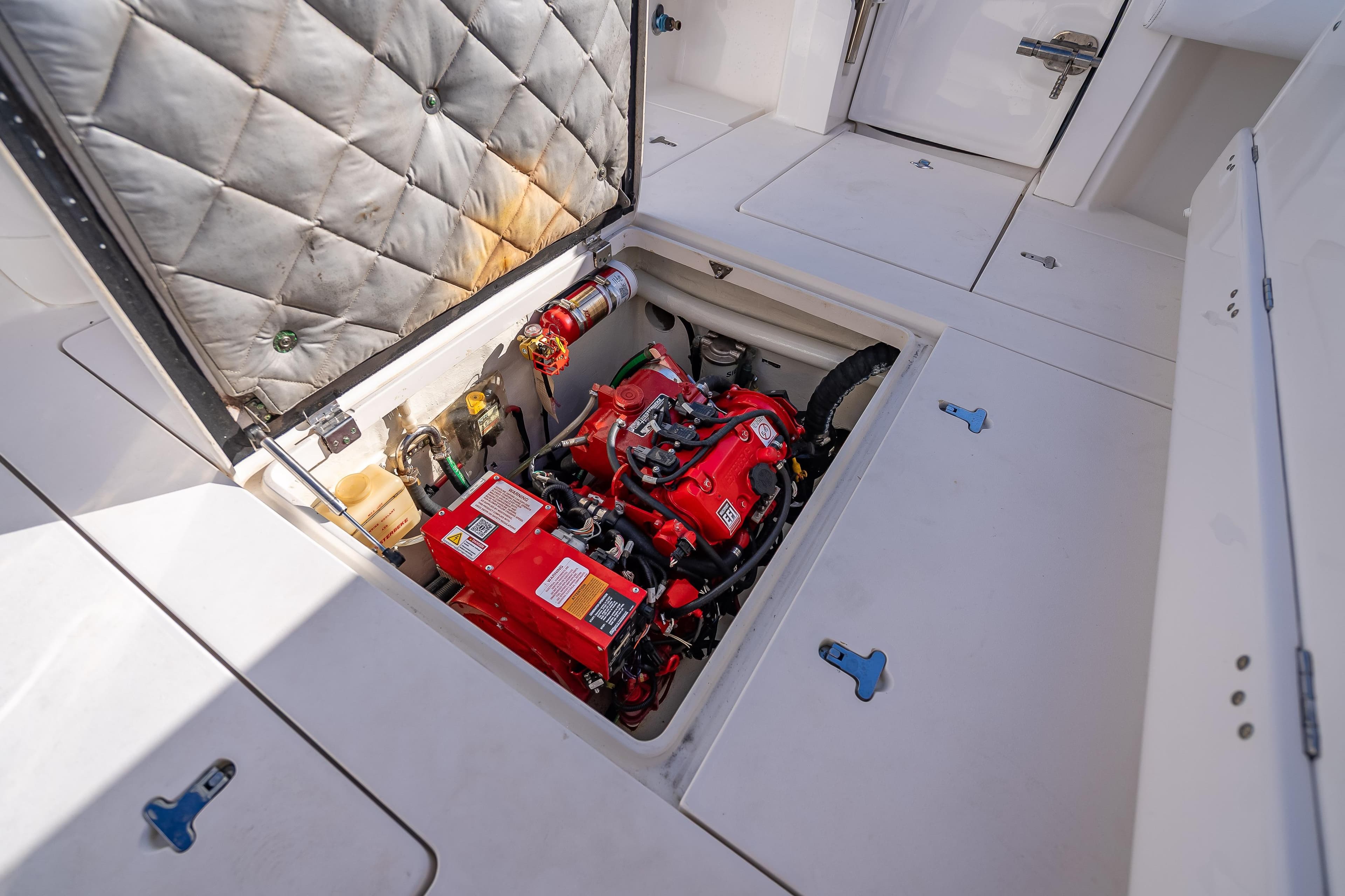 Engine compartment of a 2016 Intrepid 375 Center Console boat, featuring a red engine.