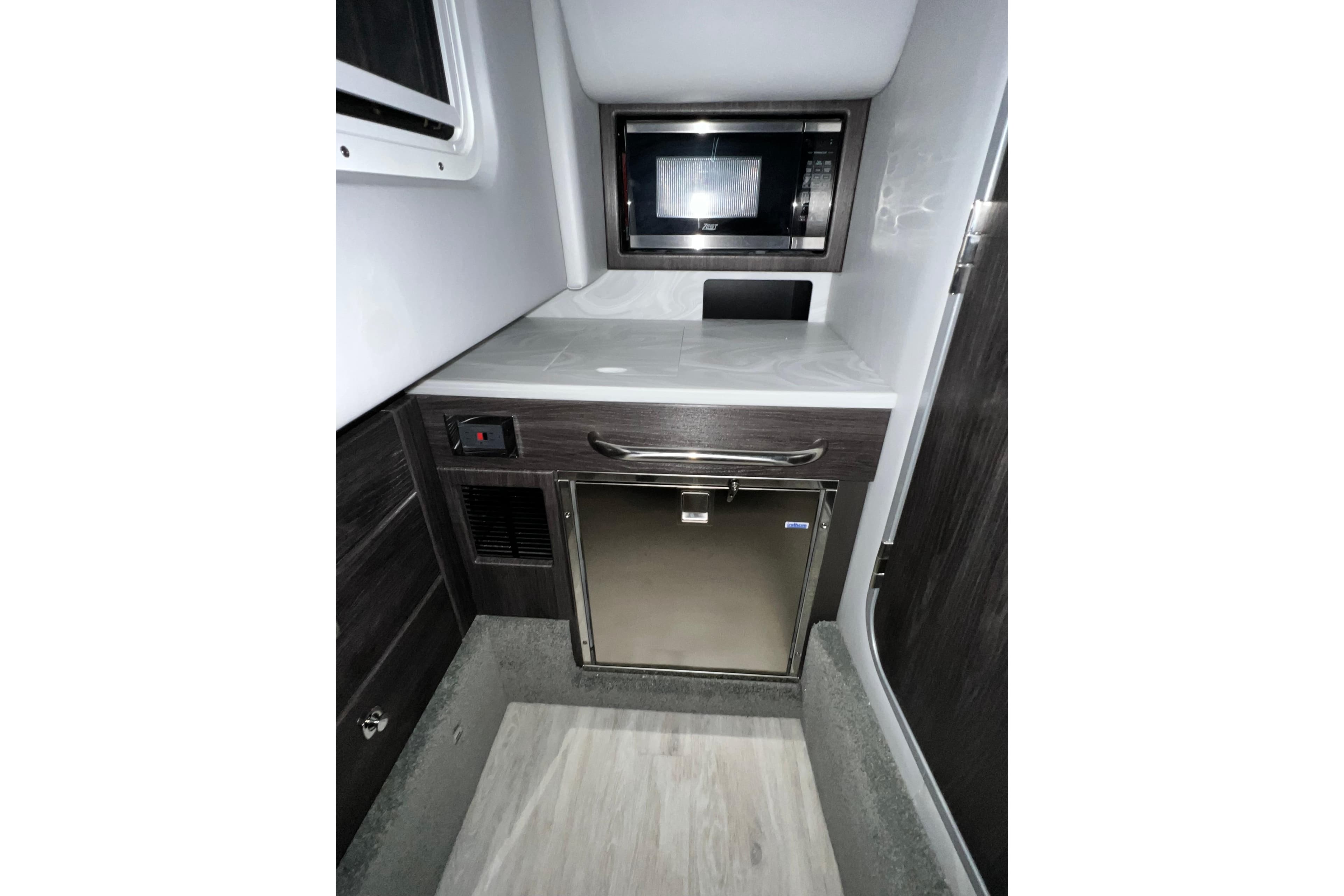 2022 Formula 350 Crossover Bowrider interior with microwave and compact fridge.
