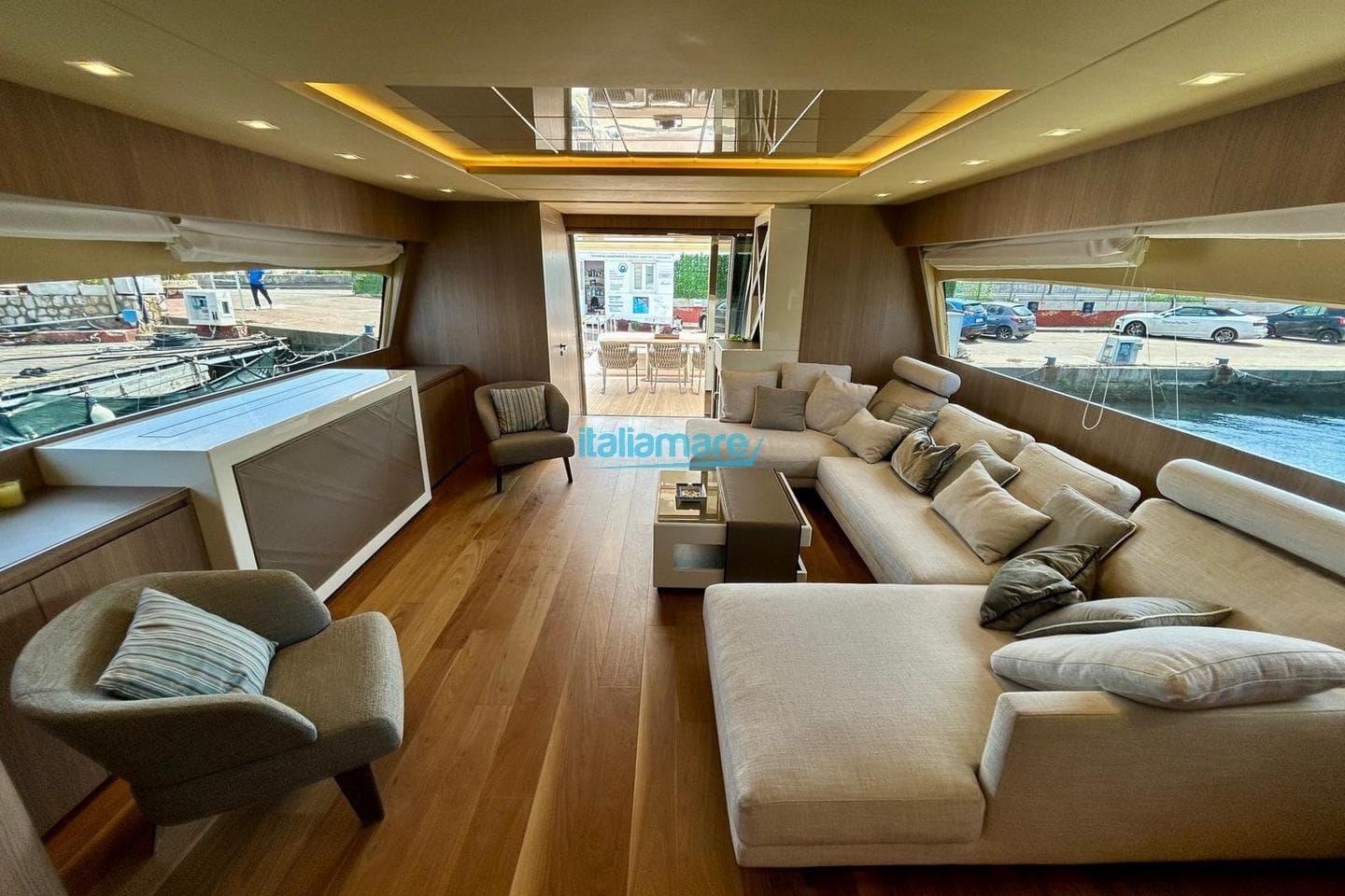 Luxurious interior of 2009 PerMare Amer 92 yacht with elegant seating and wooden flooring.