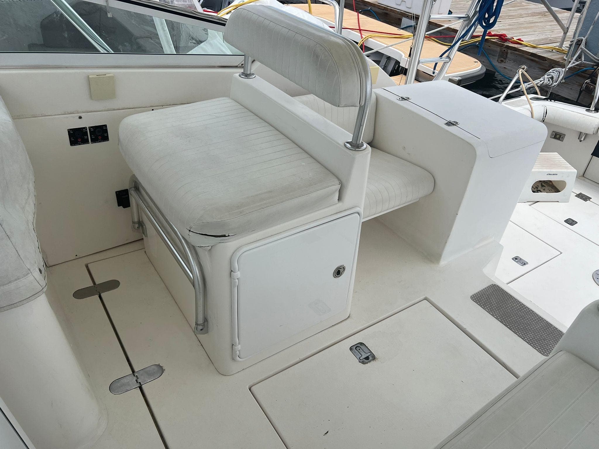 White seating area on a 2001 Topaz Express boat deck.