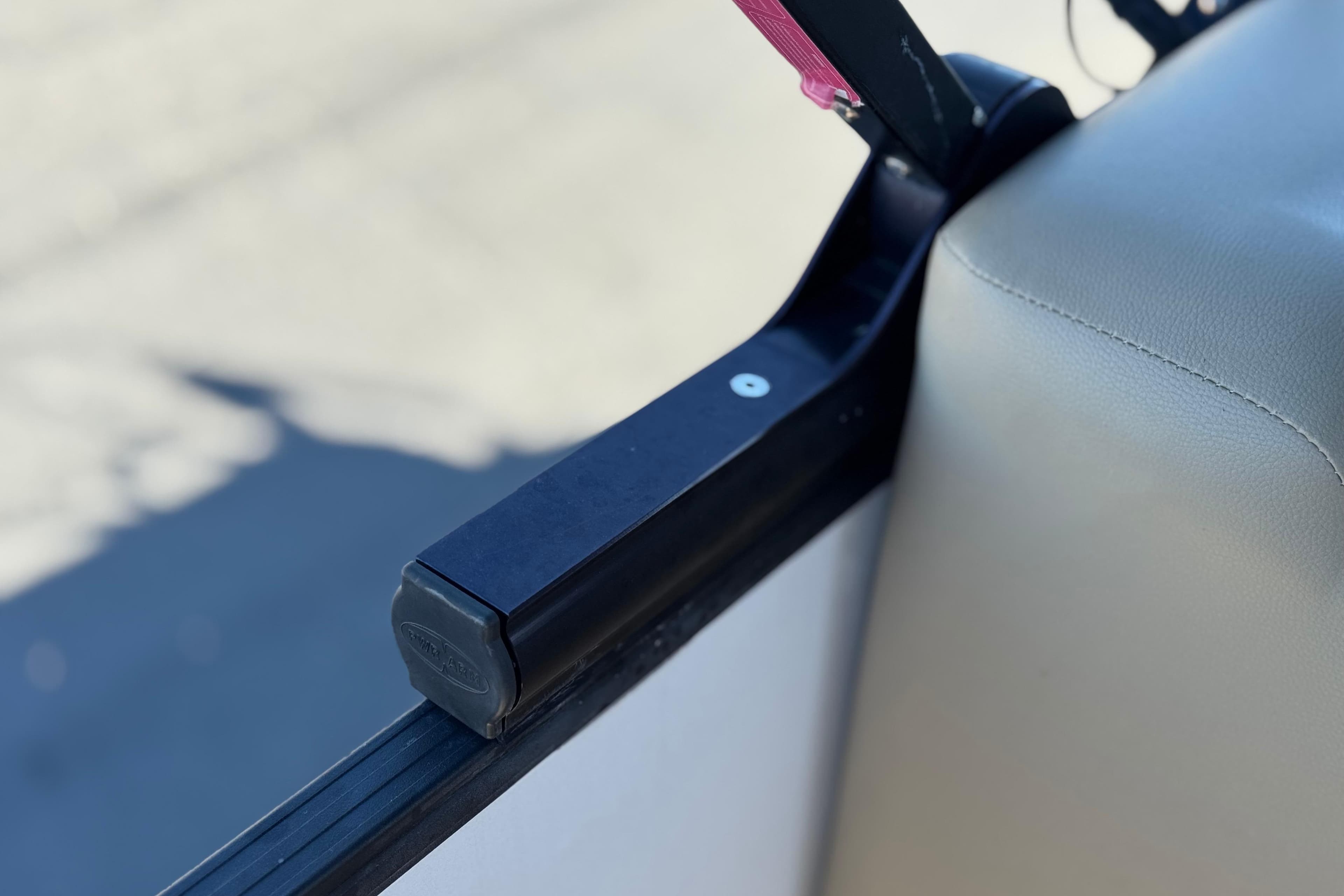 Close-up of a 2021 Starcraft SLS 3 boat seat and armrest detail.