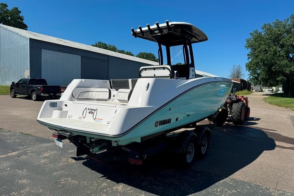 2023 Yamaha Boats 255 FSH Sport E on trailer, parked outdoors.