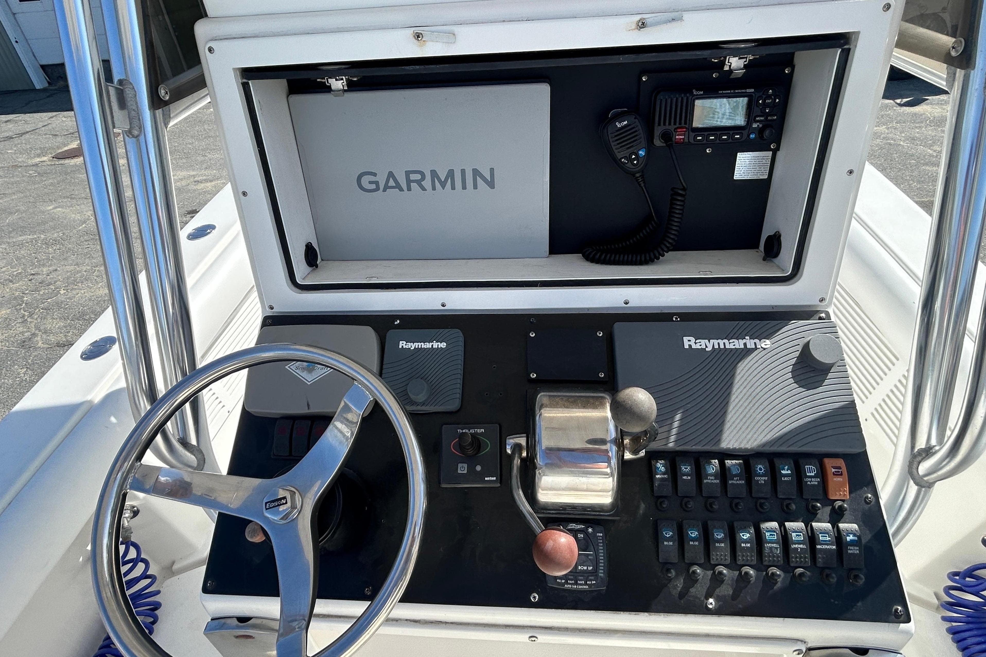 2006 Albin 26 Center Console dashboard with Garmin and Raymarine electronics.