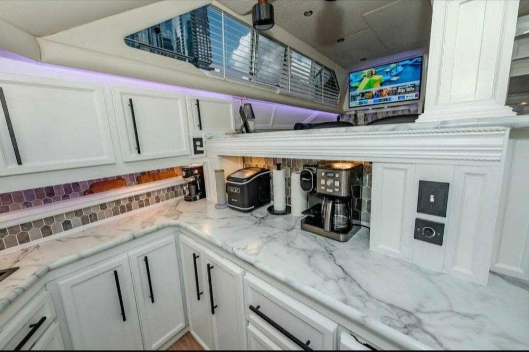 Luxurious 1991 Cruisers Yachts 3850 Aft Cabin kitchen with marble countertops and modern appliances.