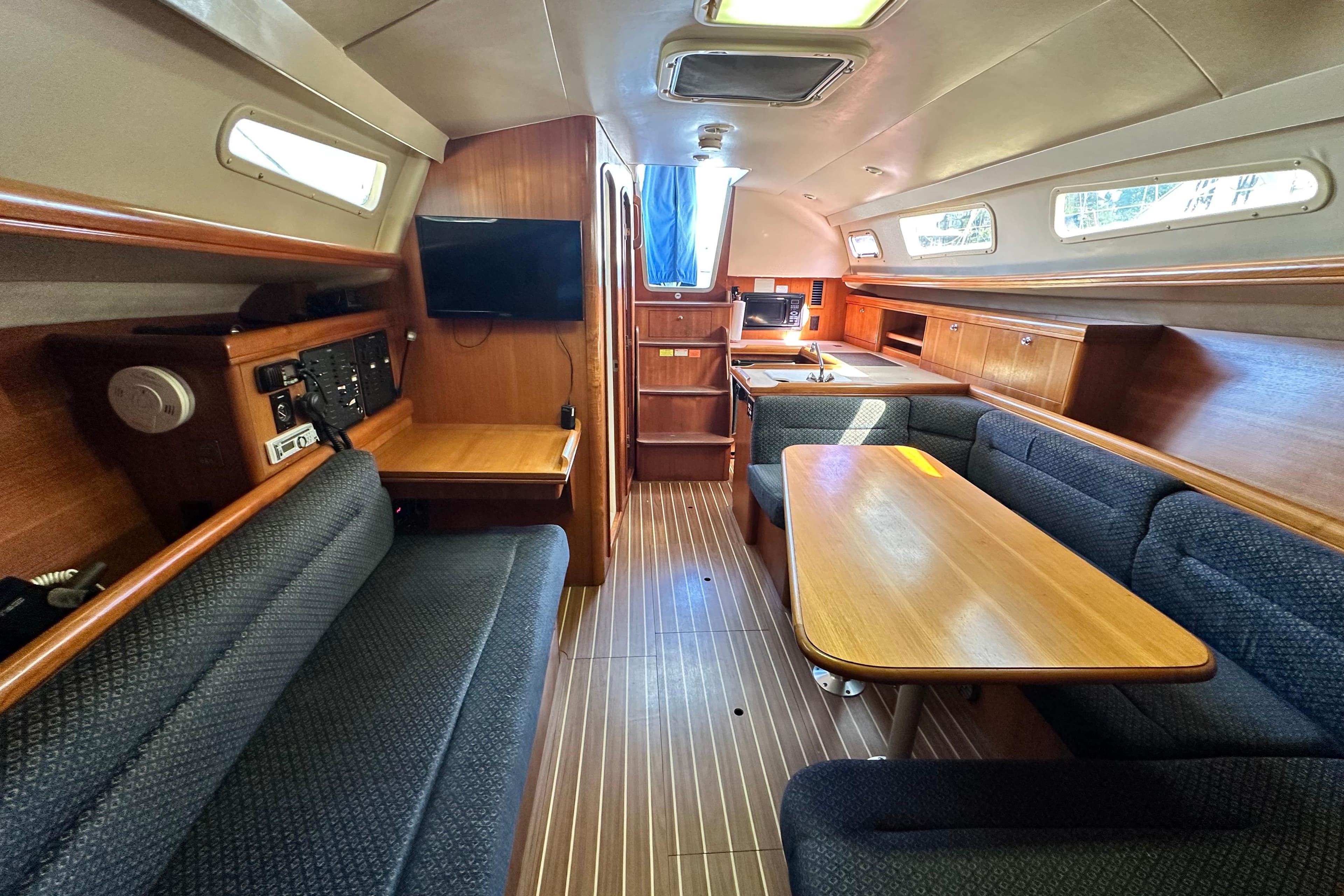Interior of a 2008 Hunter 33 sailboat with wood finishes and seating area.