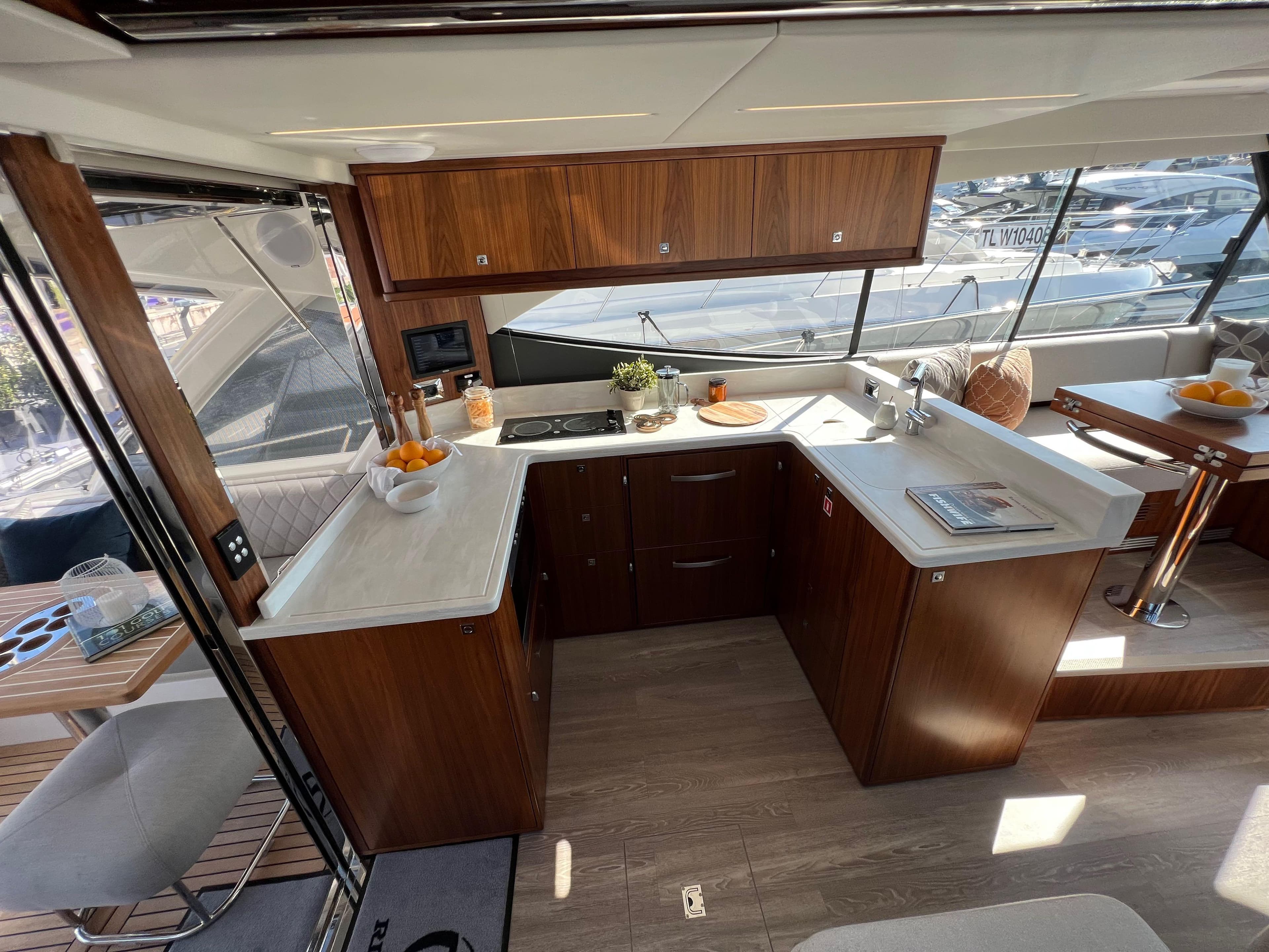 Luxurious 2022 Riviera 505 SUV yacht interior with modern kitchen and dining area.