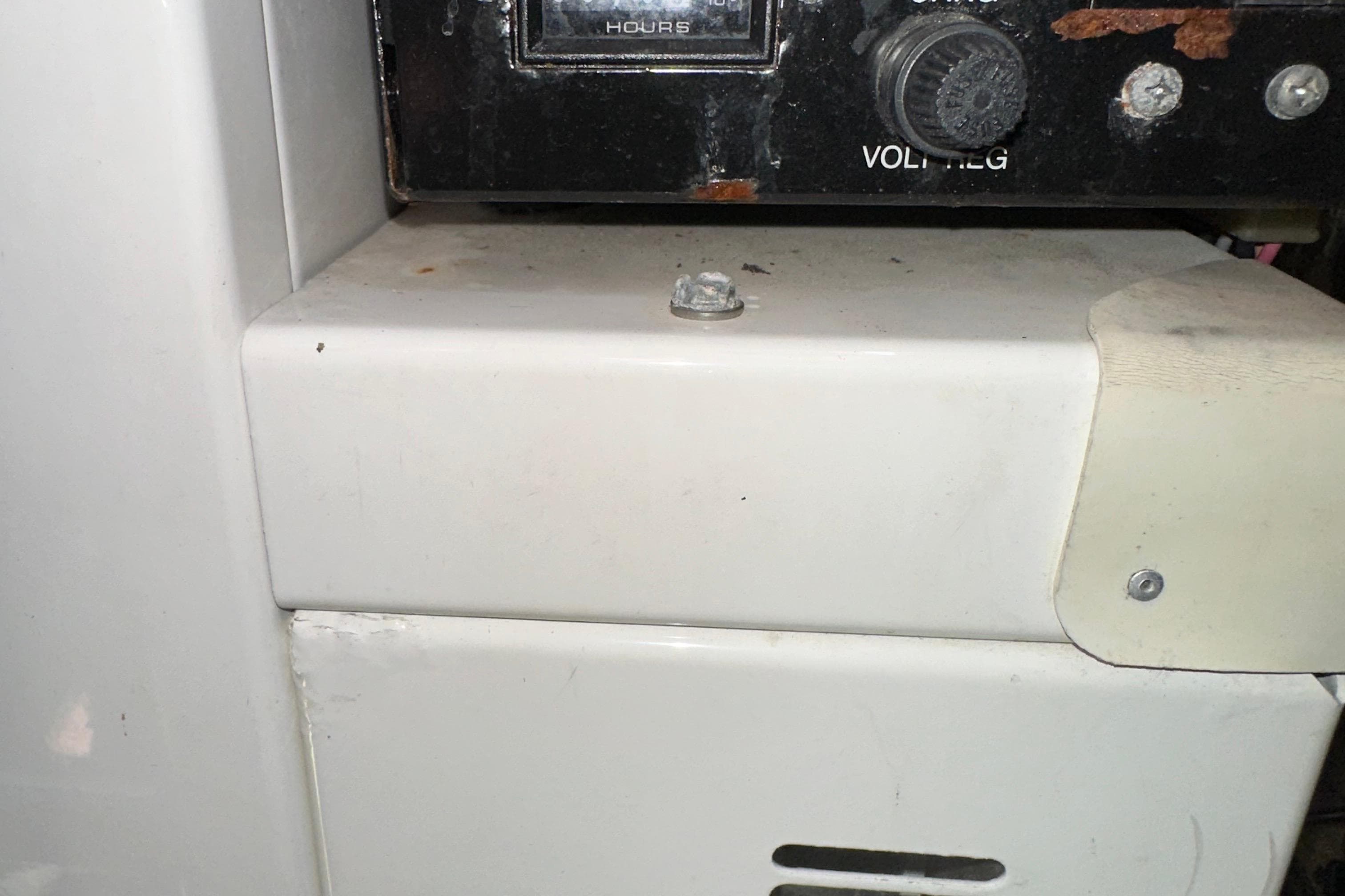 Control panel of a 2006 Larson Cabrio 350 boat, featuring a volt regulator knob.