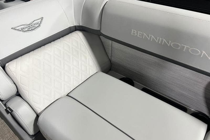 2026 Bennington 22 M Swingback boat interior with elegant gray seating and logo detailing.