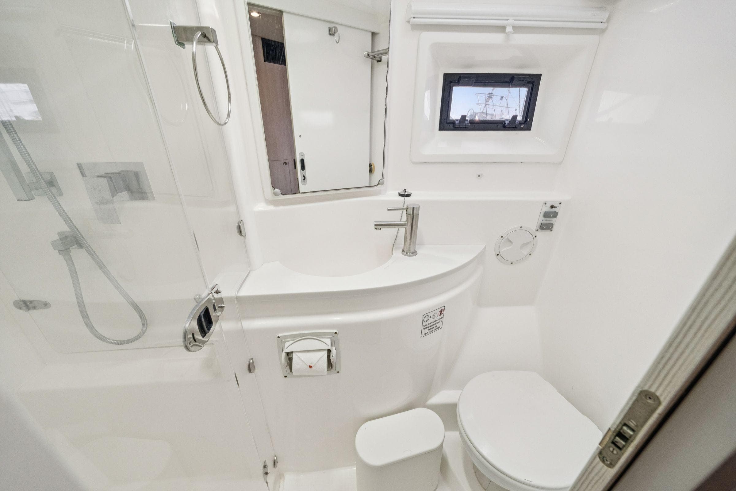 Modern bathroom in 2016 Leopard 48 yacht, featuring sleek fixtures and compact design.