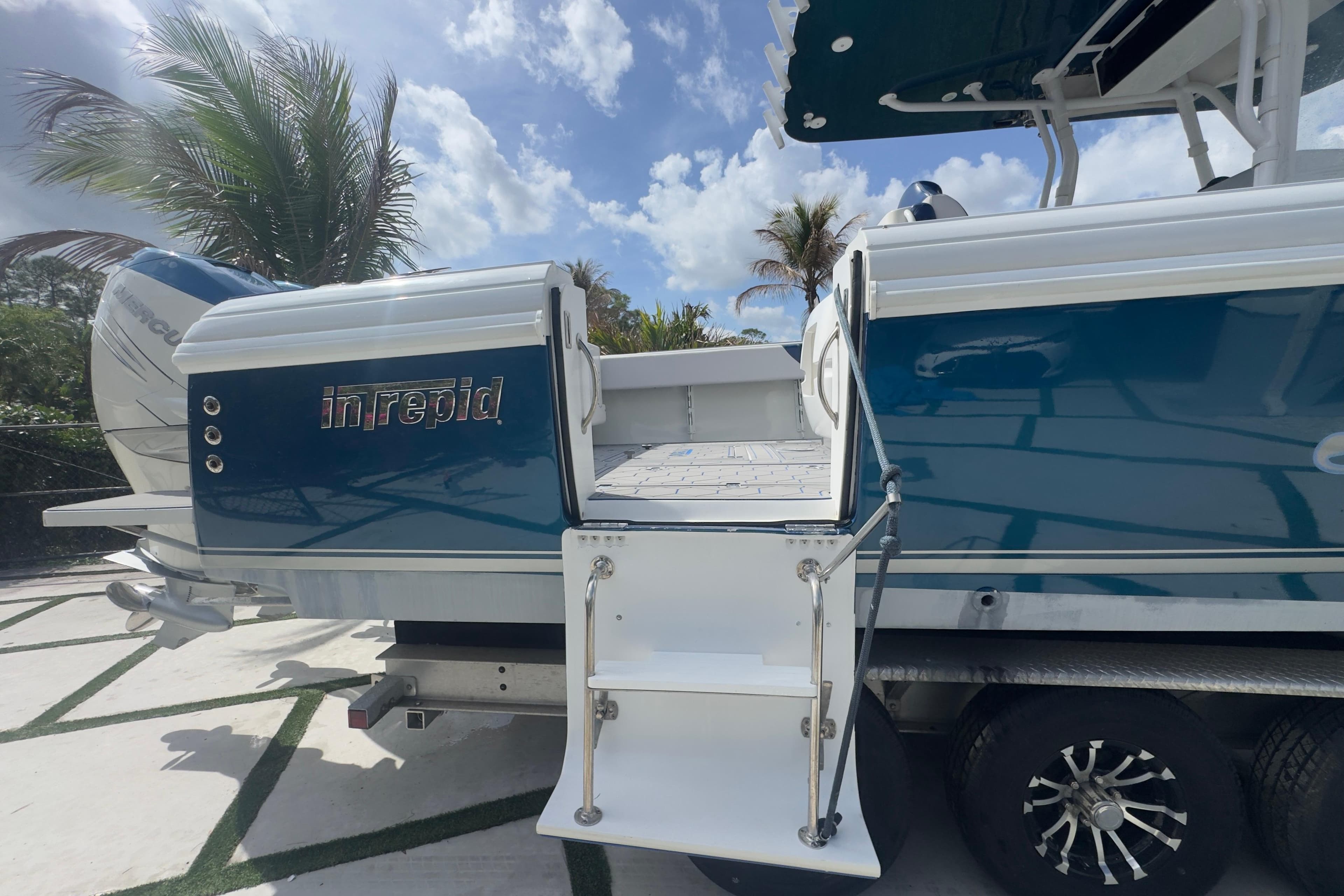 2007 Intrepid 370 Center Console boat with blue hull and rear entry ladder.