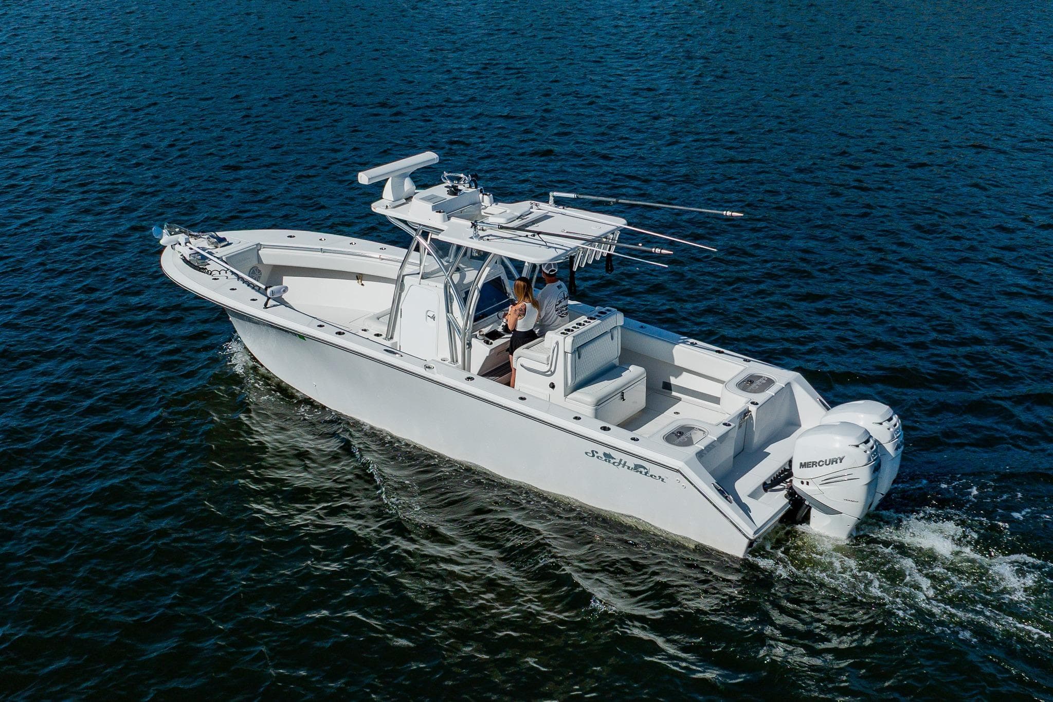2020 SeaHunter 31 Tournament boat cruising on open water with dual Mercury engines.