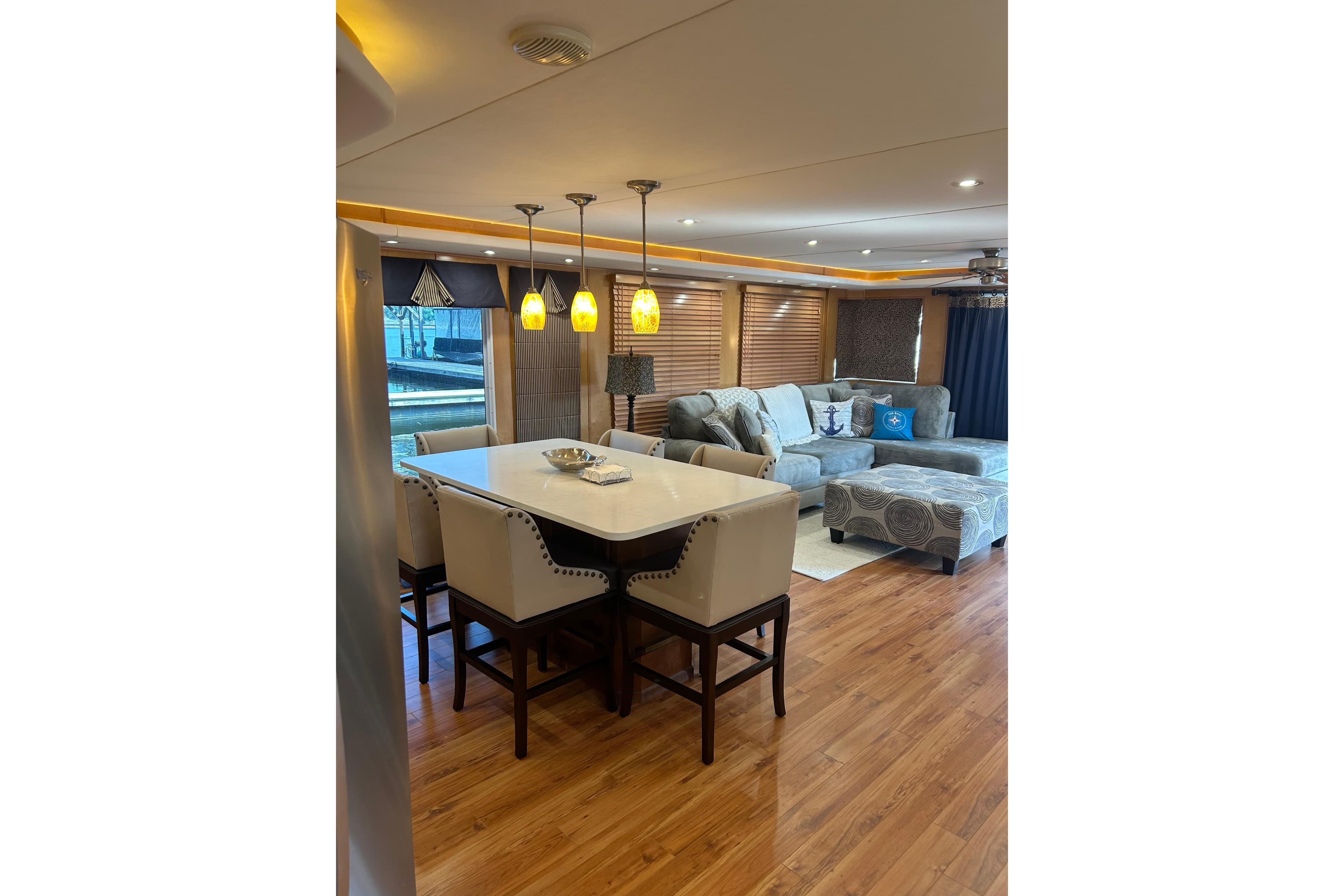 Luxurious interior of 2001 Sharpe 80 X 18 houseboat with modern dining and living area.