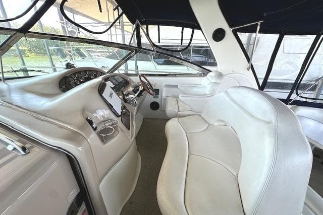 Interior of 2001 Sea Ray 380 Sundancer boat with white leather seating and control panel.