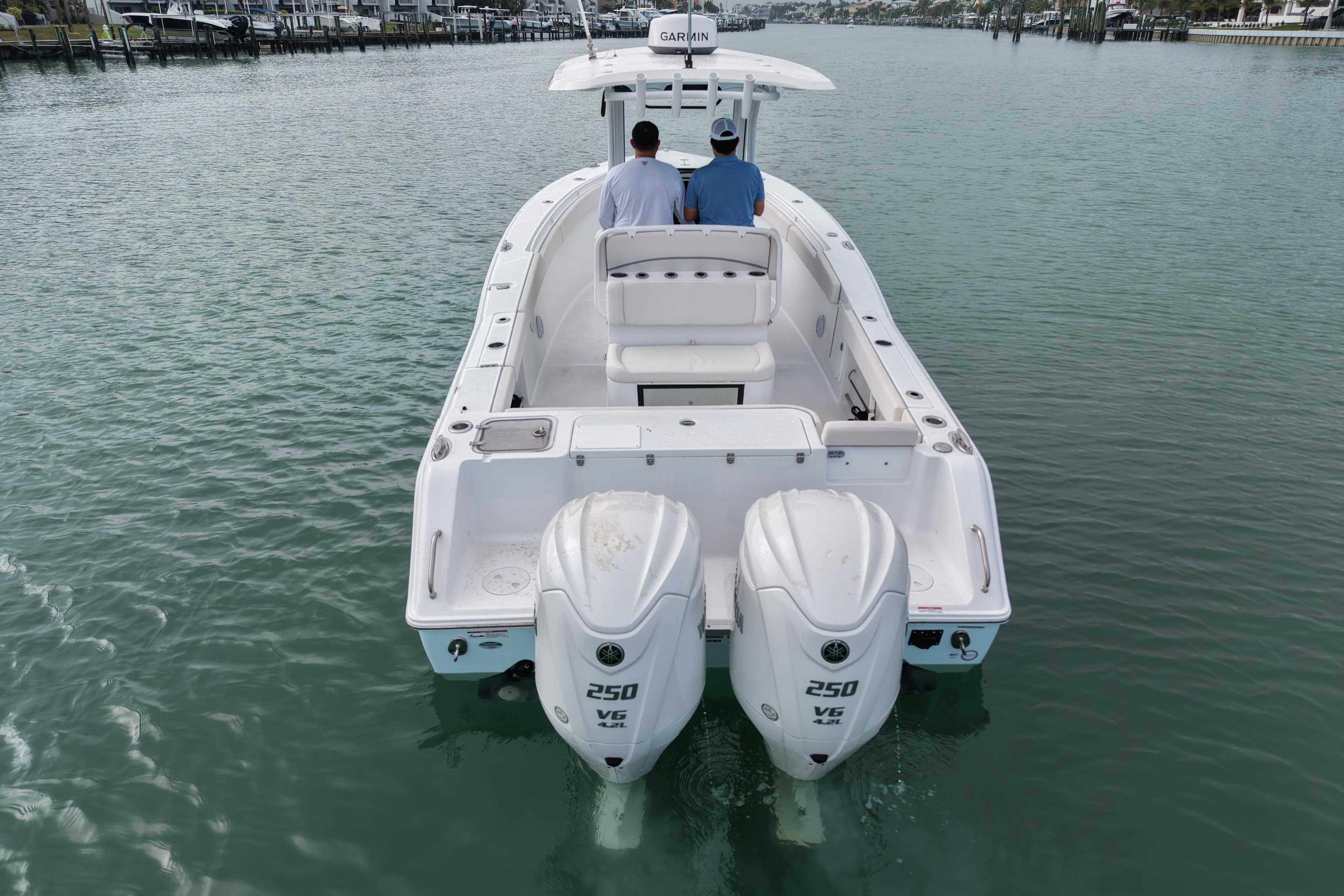 2024 Sea Hunt Gamefish 27 Coffin Box boat with dual 250 V6 engines on calm water.