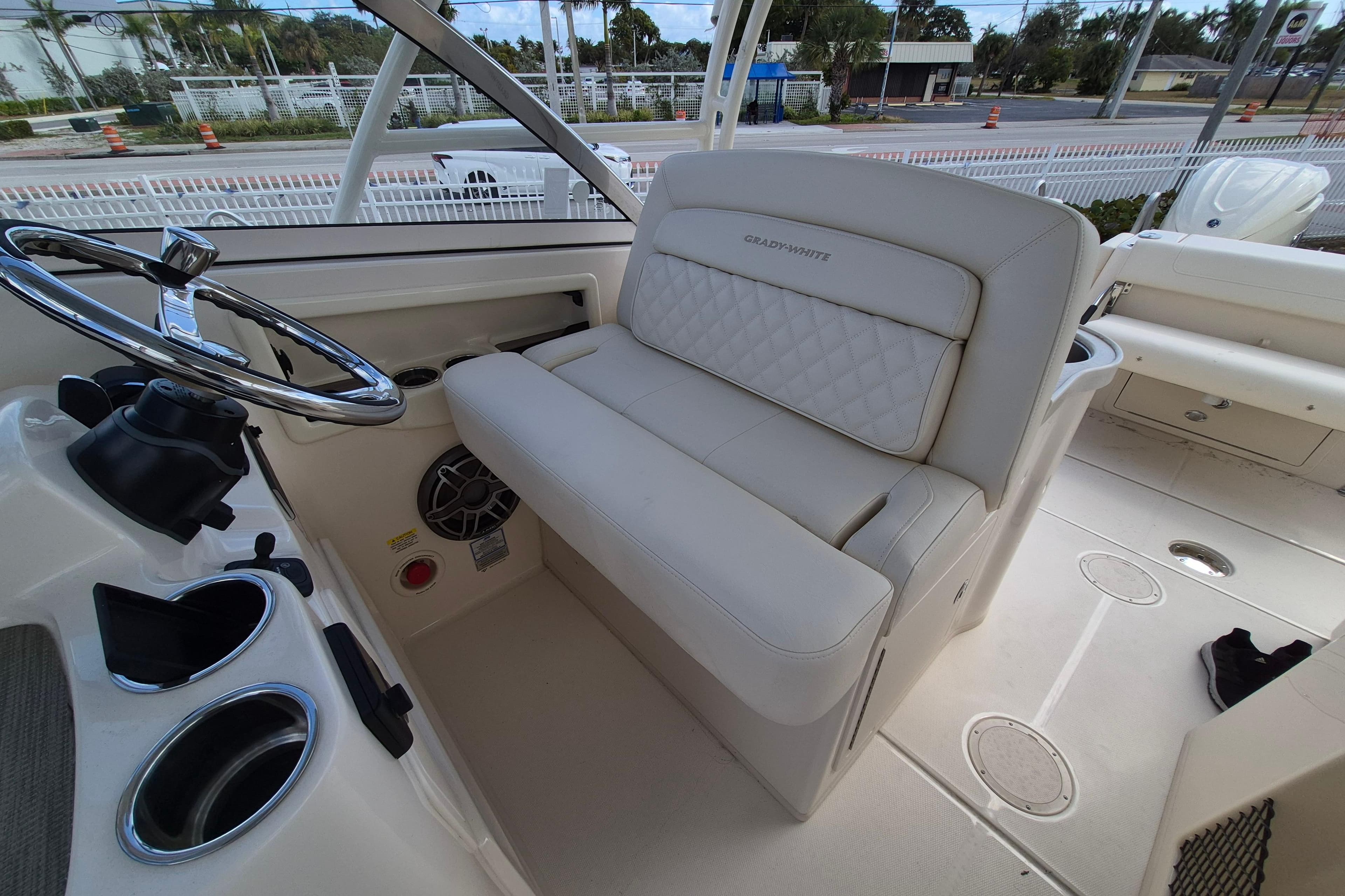 2026 Grady-White Freedom 307 boat interior with steering wheel and cushioned seating.