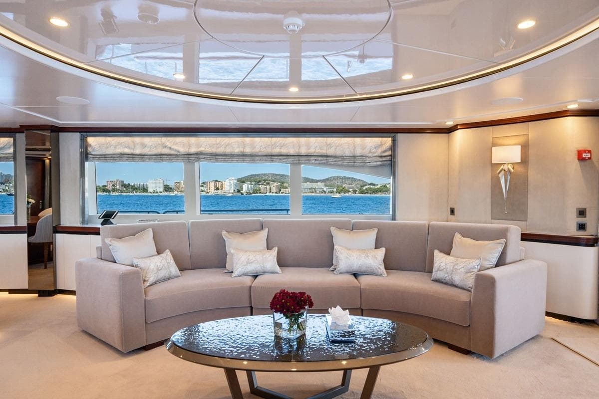 Luxurious interior of 2001 CRN Magnifica yacht with elegant seating and ocean view.
