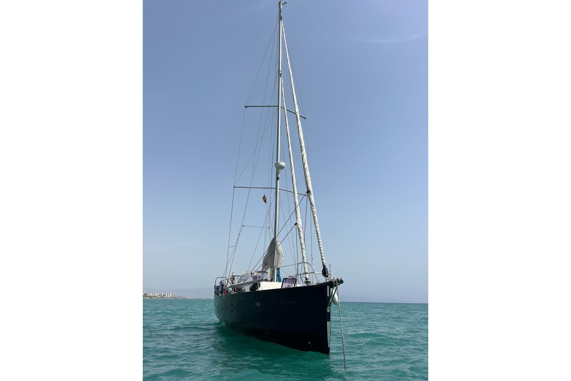Sailing yacht RM Yachts 1260, 2013 model, anchored in calm blue waters.