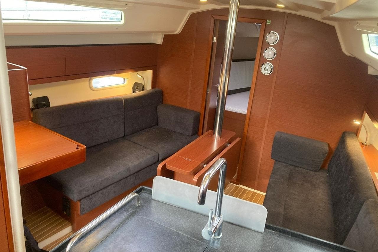 Interior of a 2020 Hanse 348 yacht with modern seating and wooden finishes.