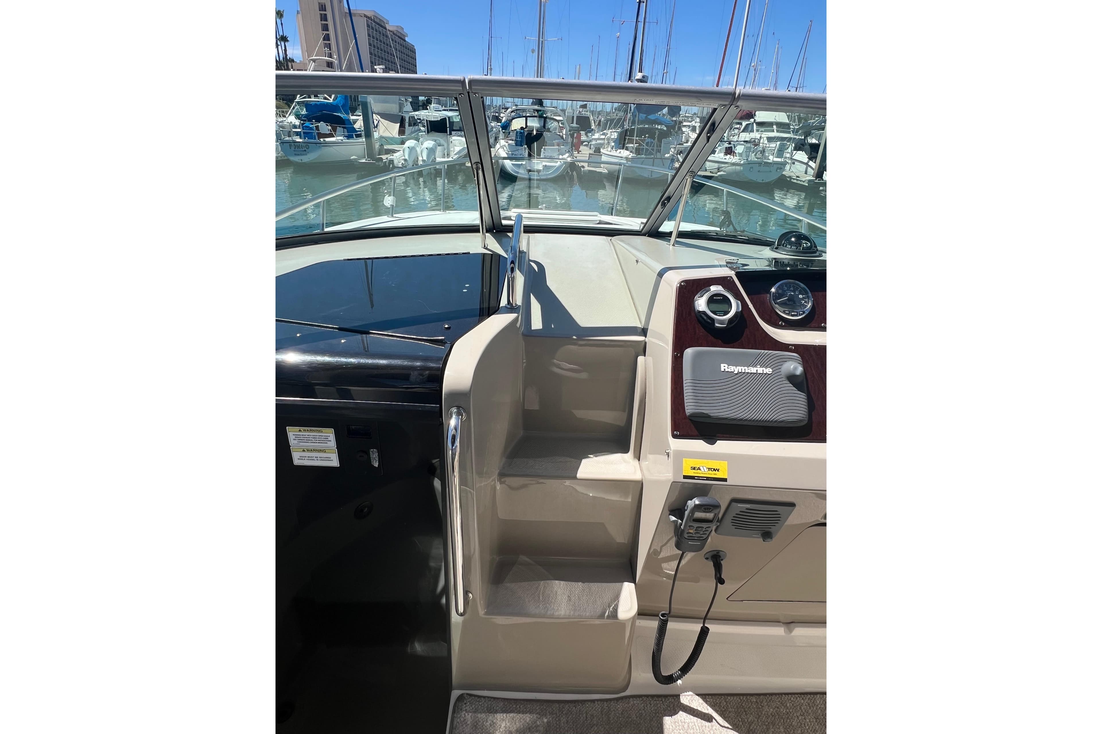 2013 Sea Ray Sundancer 280 helm with Raymarine equipment, docked at marina.