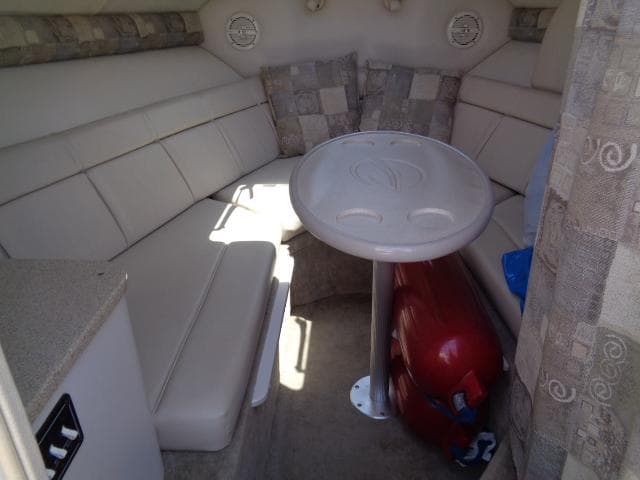 Interior of 2006 Crownline 220 CCR boat with cushioned seating and table.