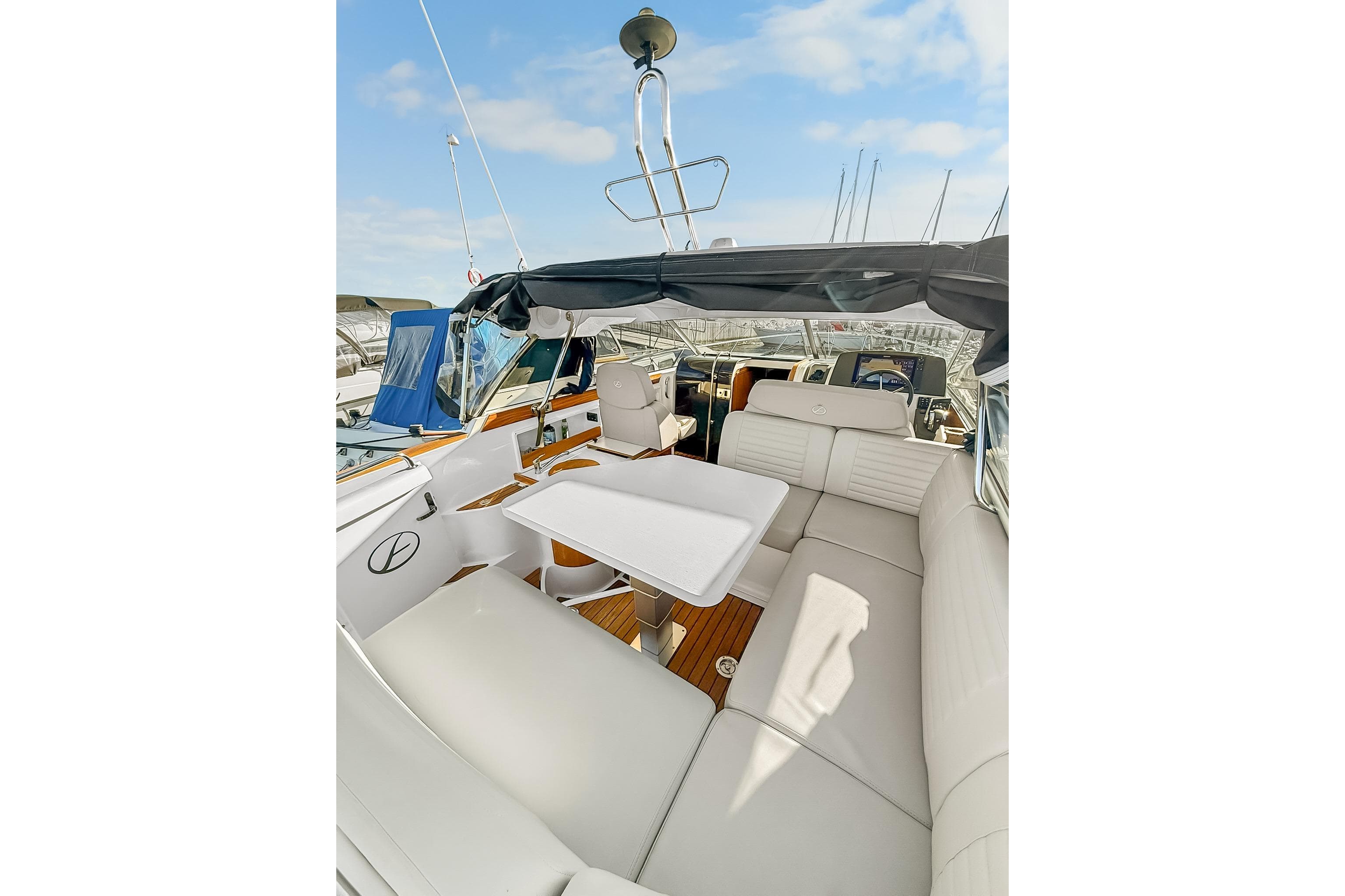 Luxurious interior of 2021 Aquador 28 HT boat with plush seating and table.