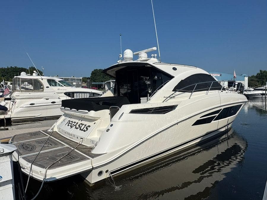 2015 Sea Ray 510 Sundancer yacht docked at marina, sunny day.