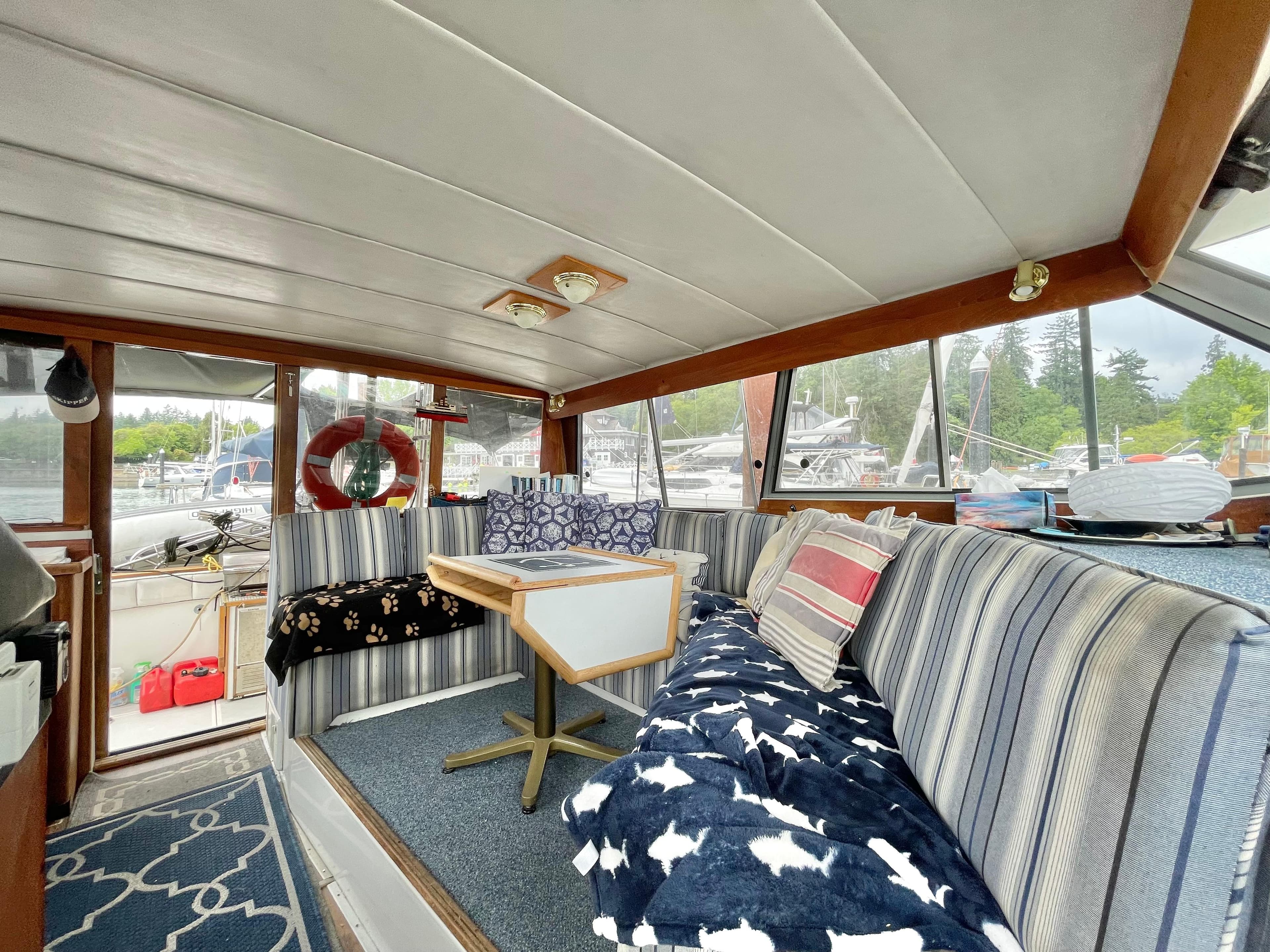 Interior of 1987 Bayliner 3870 Motoryacht with striped seating and nautical decor.