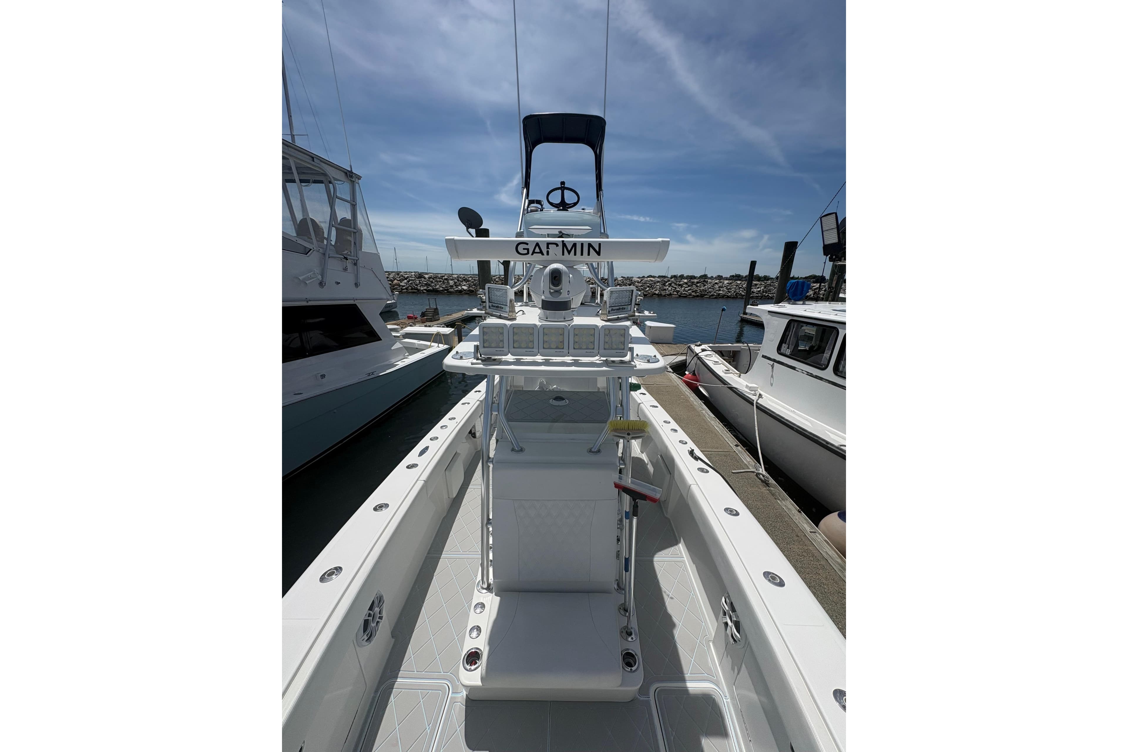 2019 Concept 392 ProFish boat with Garmin equipment, docked at a marina under clear skies.