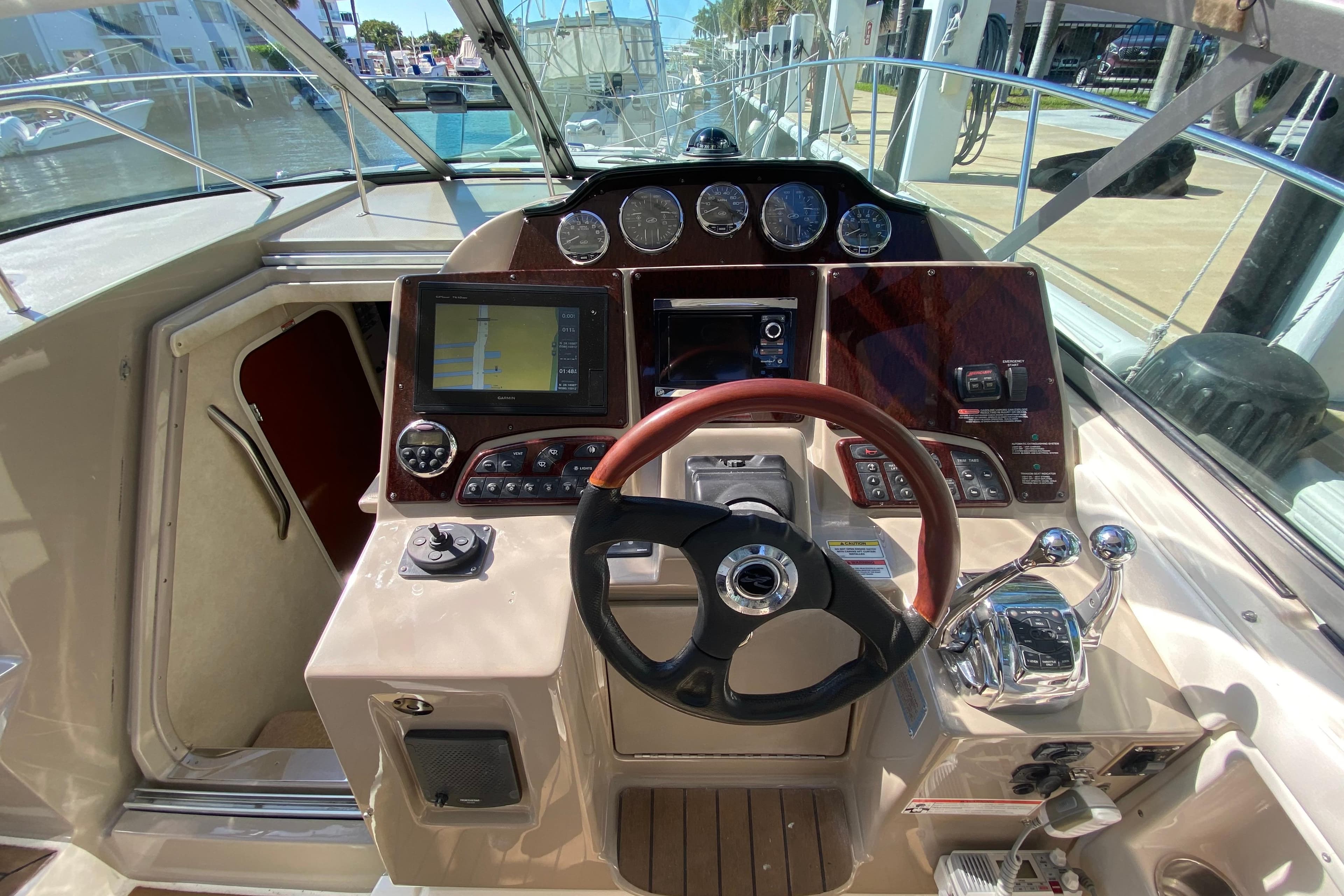 2008 Sea Ray Sundancer 330 helm with navigation controls and steering wheel.