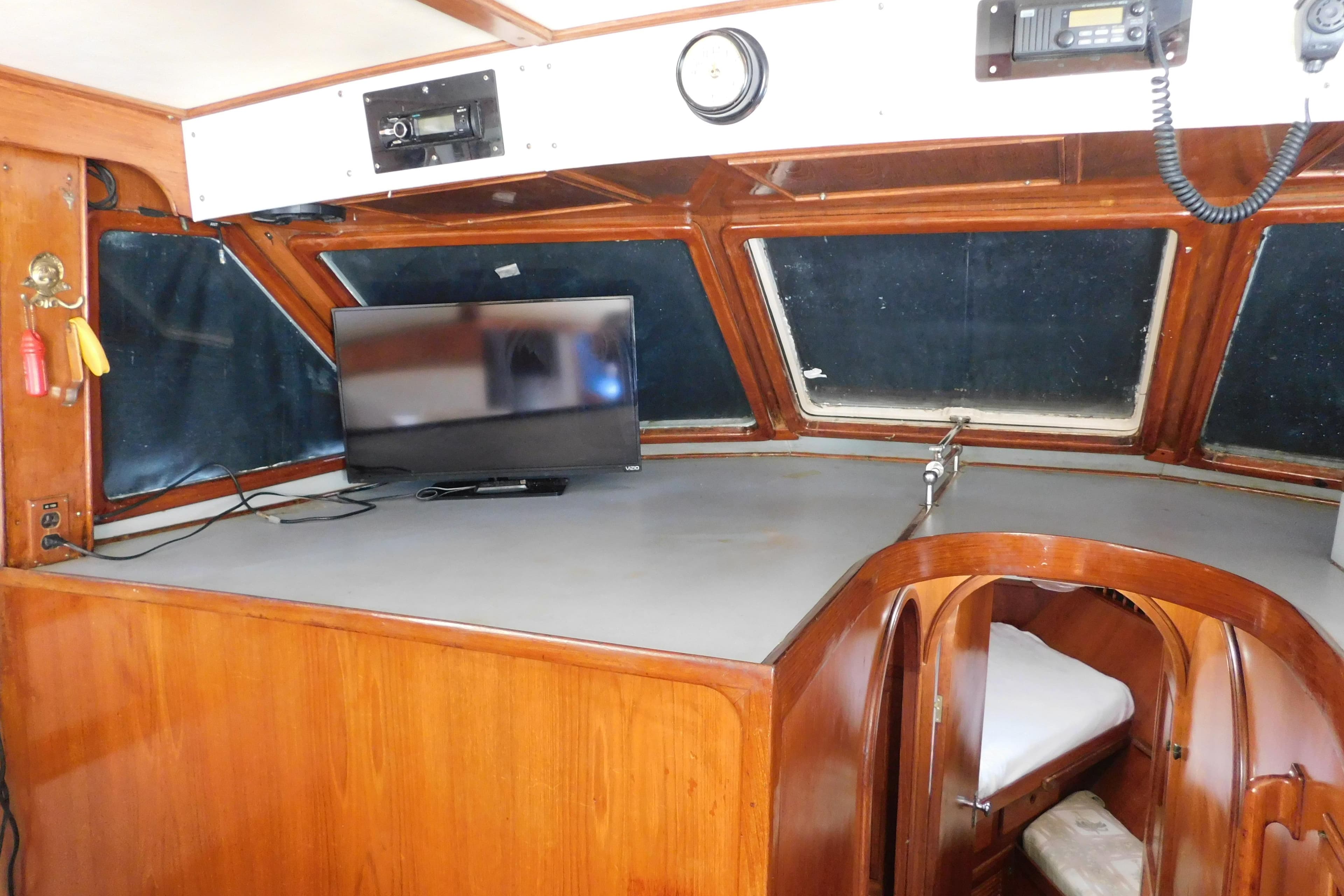 Interior of 1984 Kha Shing 40 Spindrift yacht with TV and wooden finish.