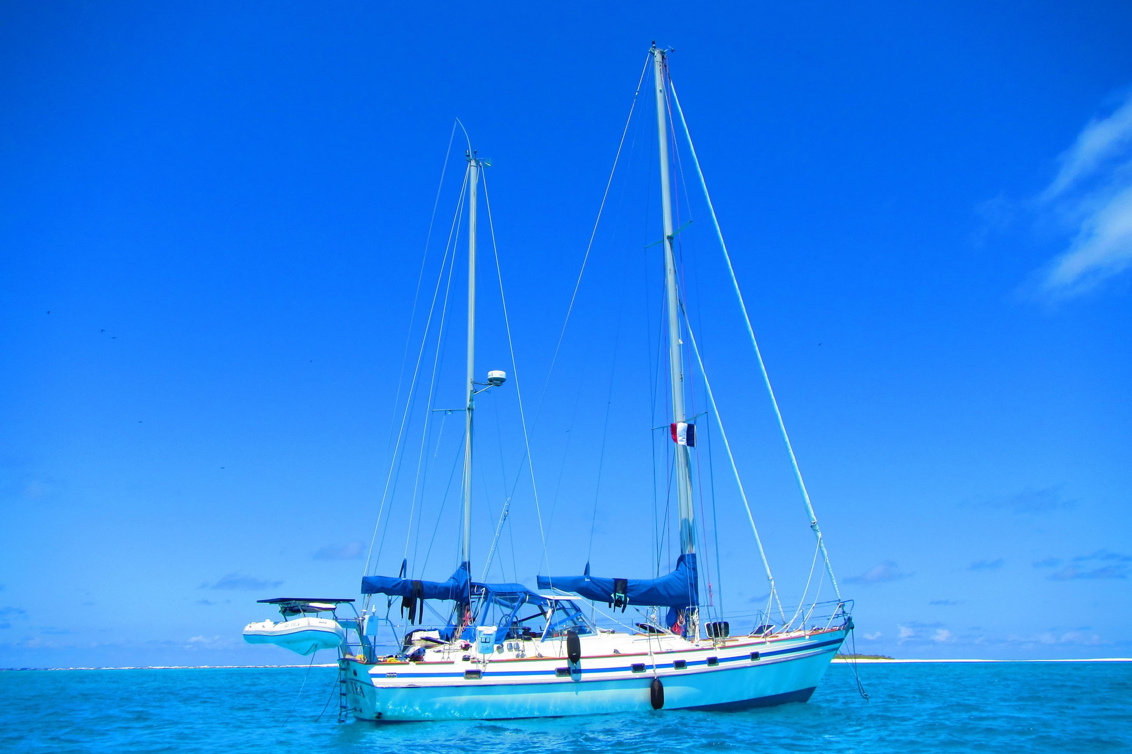1984 Contest Yachts Blue Water Cruising Ketch sailing on clear blue ocean.
