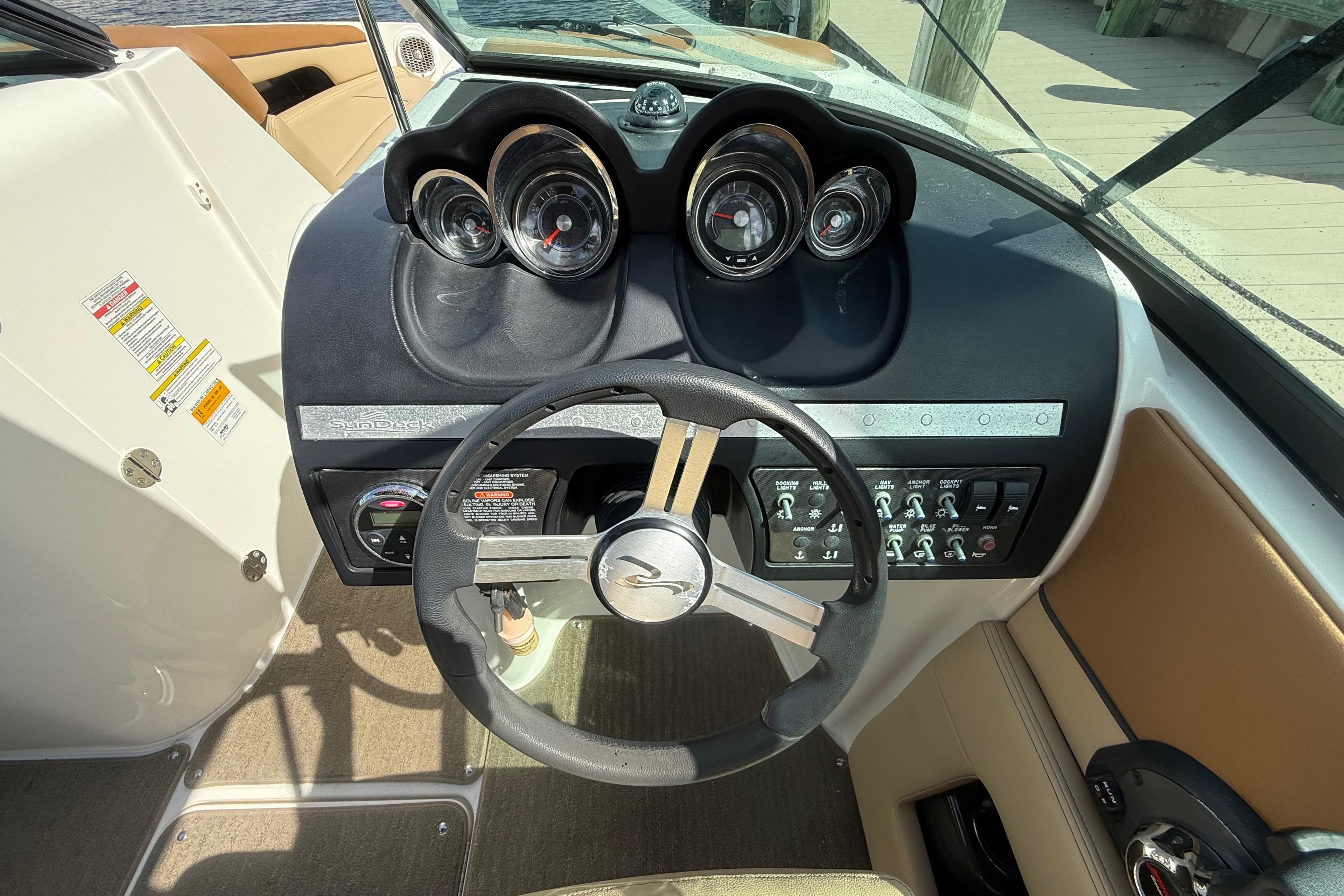 2014 Sea Ray 260 Sundeck dashboard with steering wheel and instrument panel.