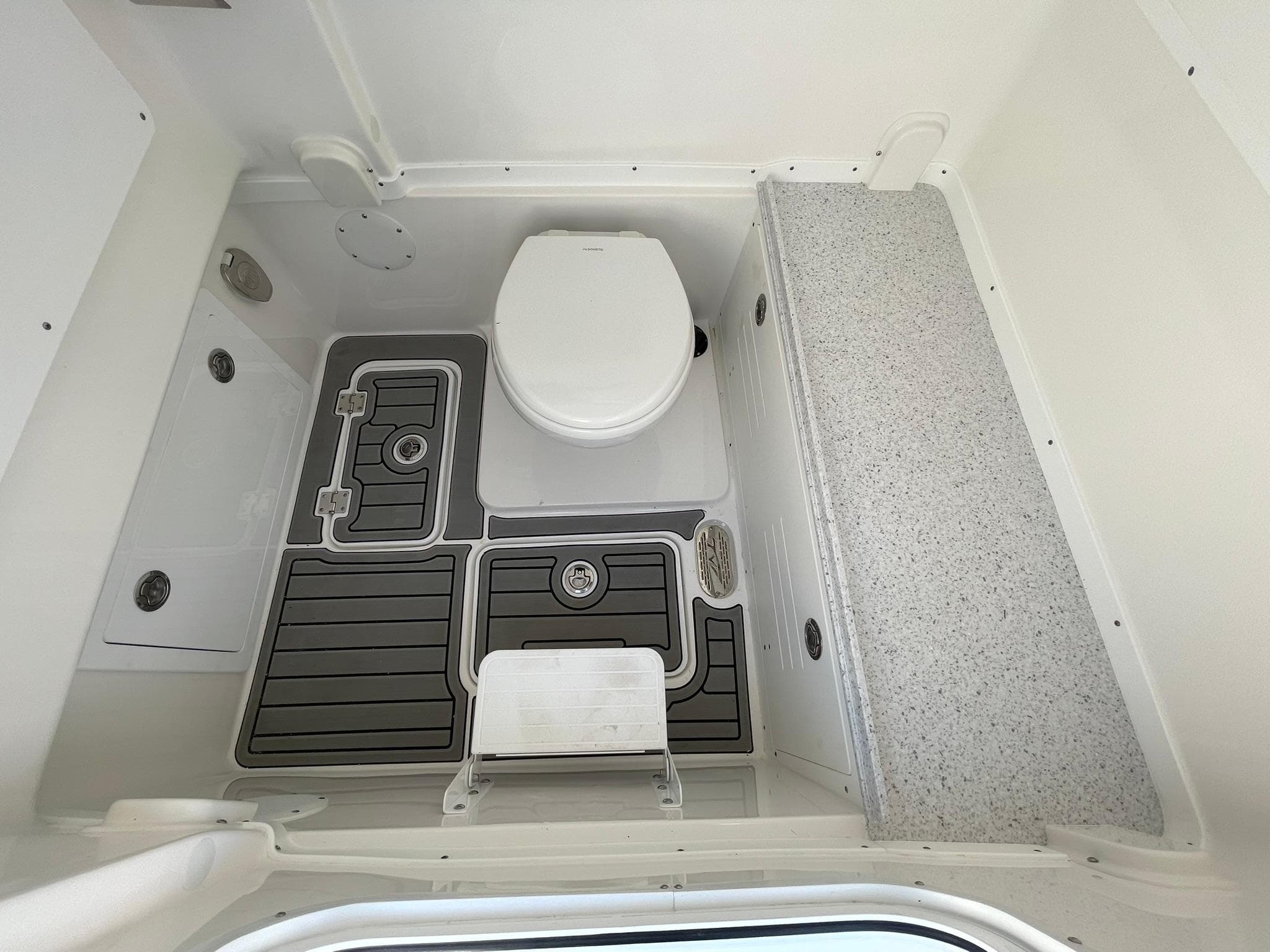 2026 Tidewater 302 CC Adventure boat interior with toilet and non-slip flooring.