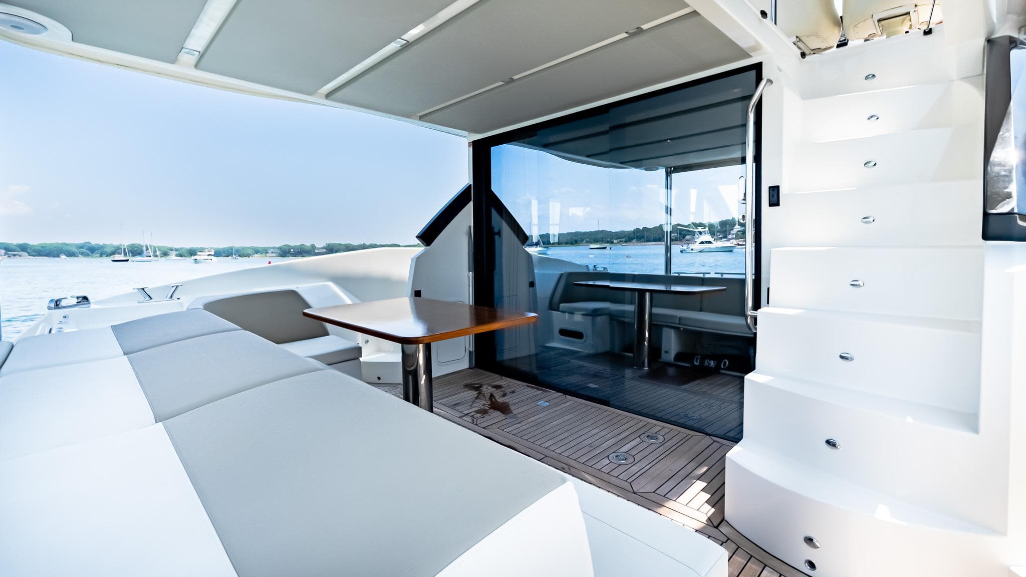Luxurious 2017 Absolute 50 Fly yacht interior with seating, table, and stairs.