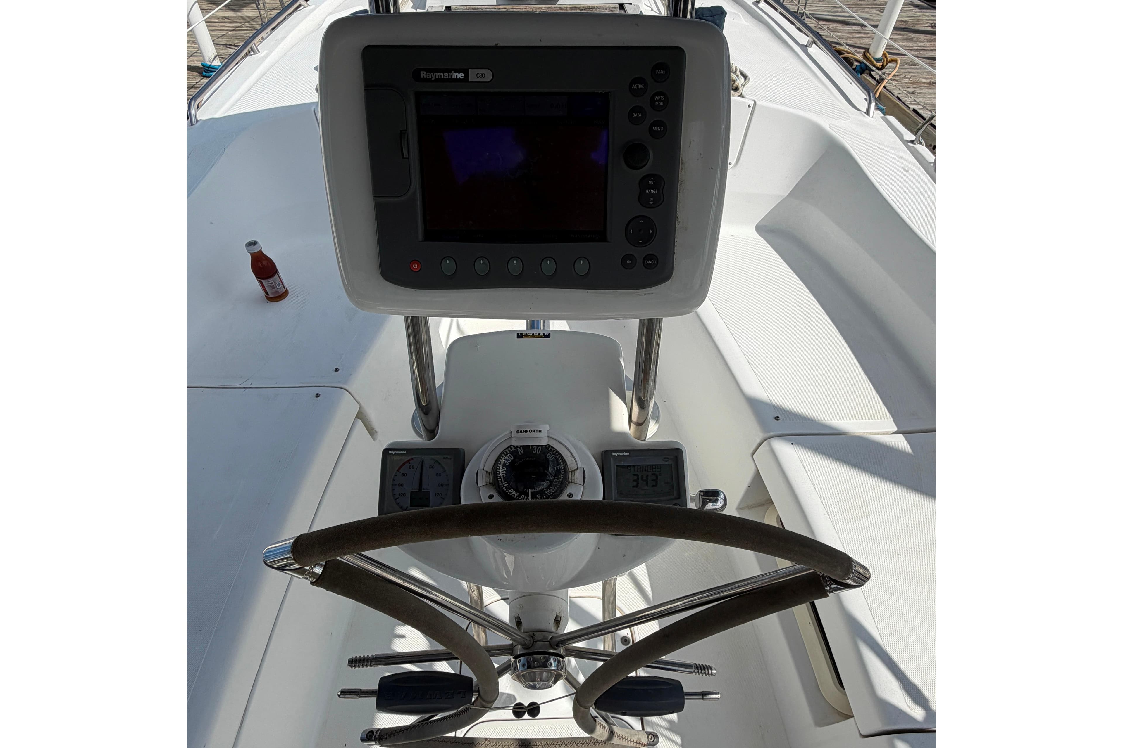 Steering console of a 2008 Hunter 36 sailboat with navigation equipment.