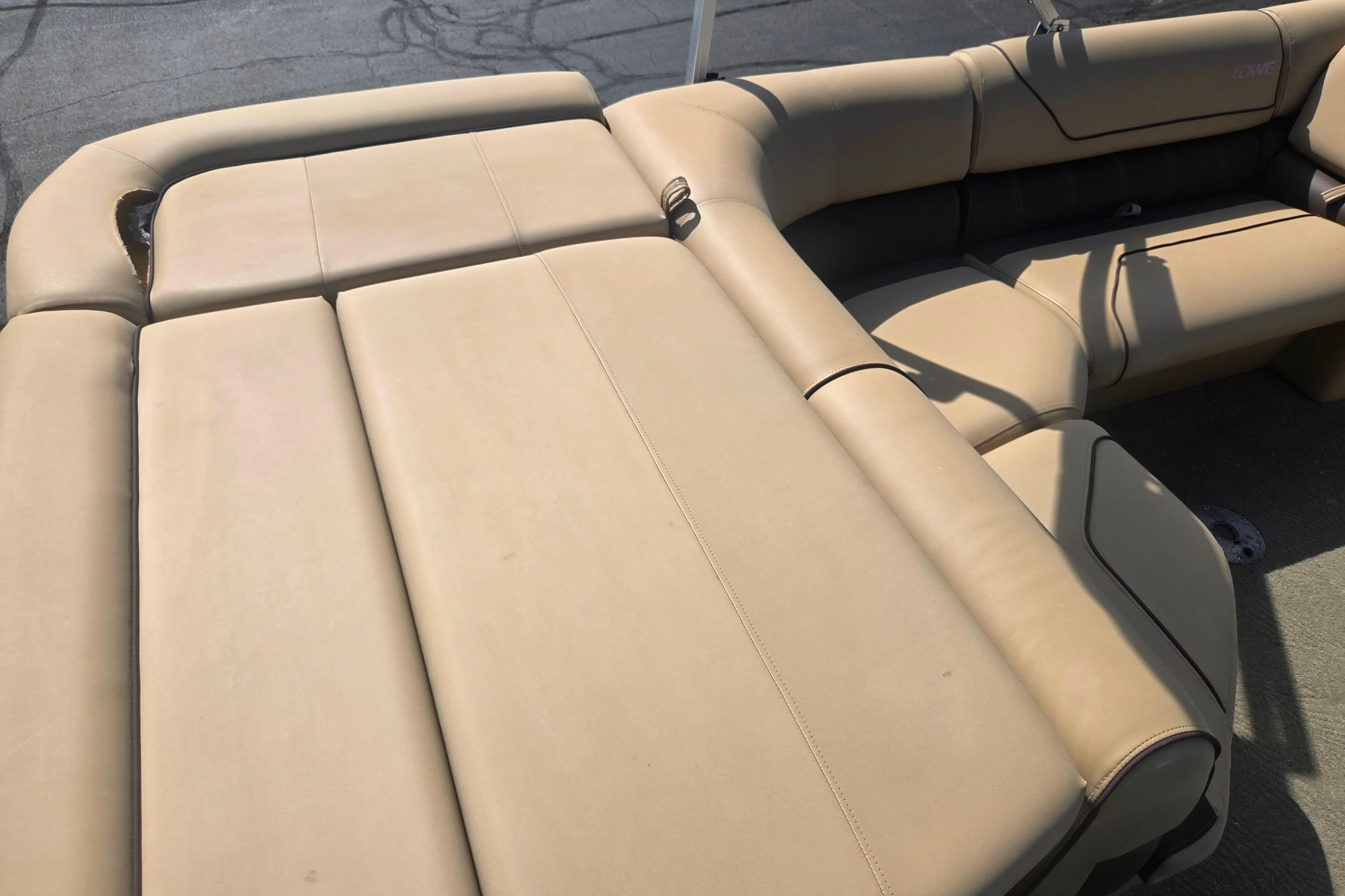 2017 Lowe SS 250 boat with beige cushioned seating, ideal for comfort and relaxation.