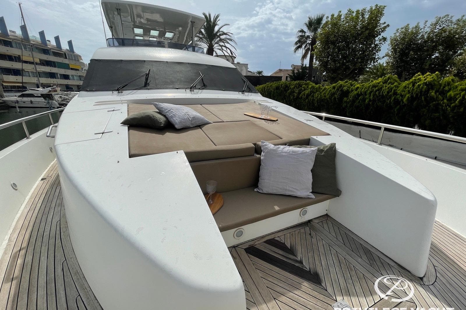 Luxury Monte Fino 76 yacht deck with cushions, 2006 model, docked in marina.