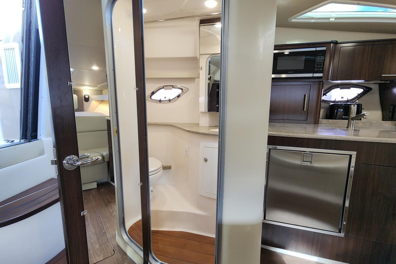 Interior of 2018 Regal 35 Sport Coupe featuring kitchen and bathroom amenities.