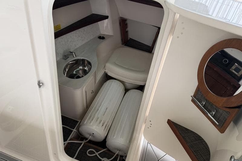 2025 Grady-White Freedom 325 boat interior with sink, toilet, and storage space.