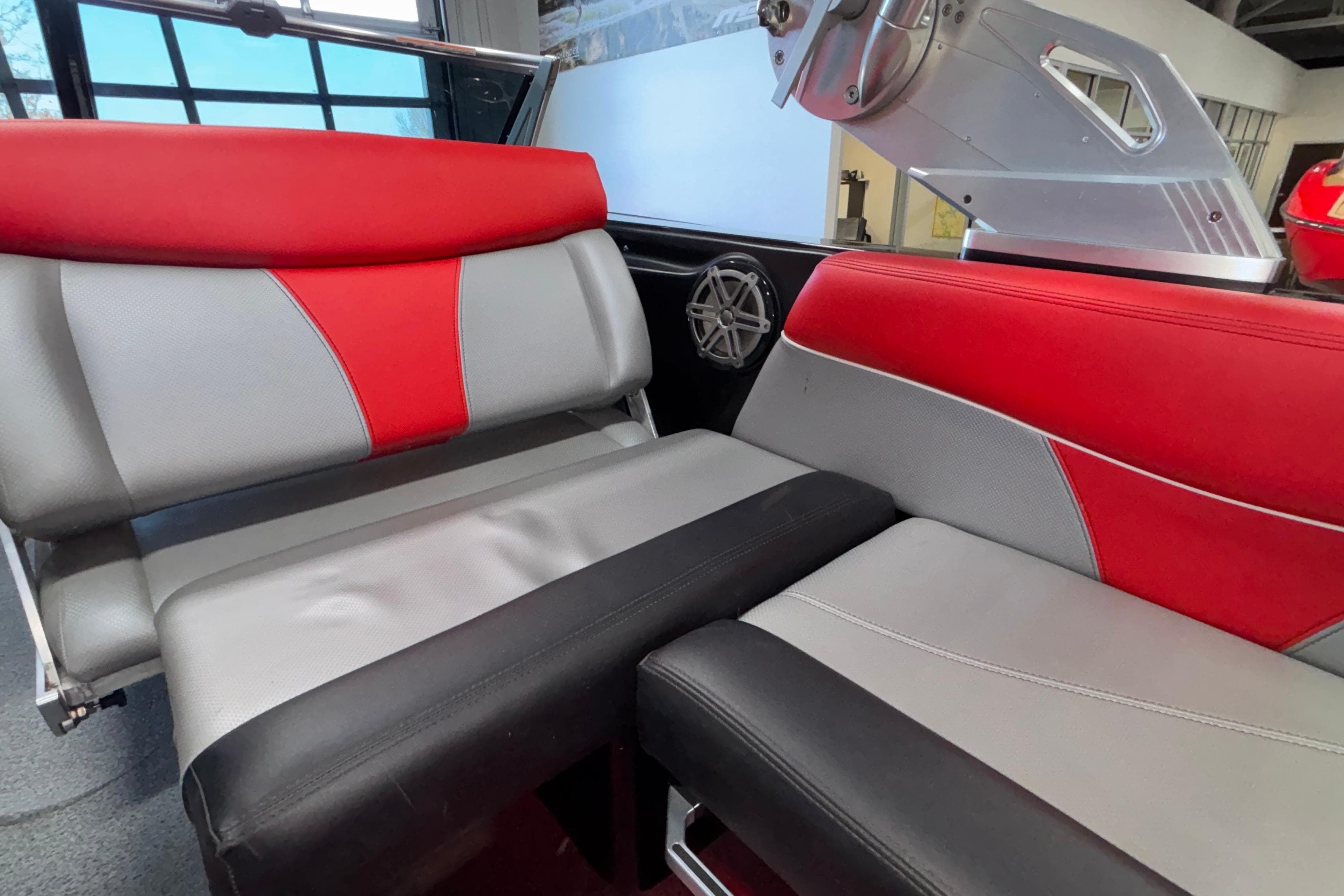 2017 MasterCraft X46 interior with red, gray, and black seating, showcasing modern design.
