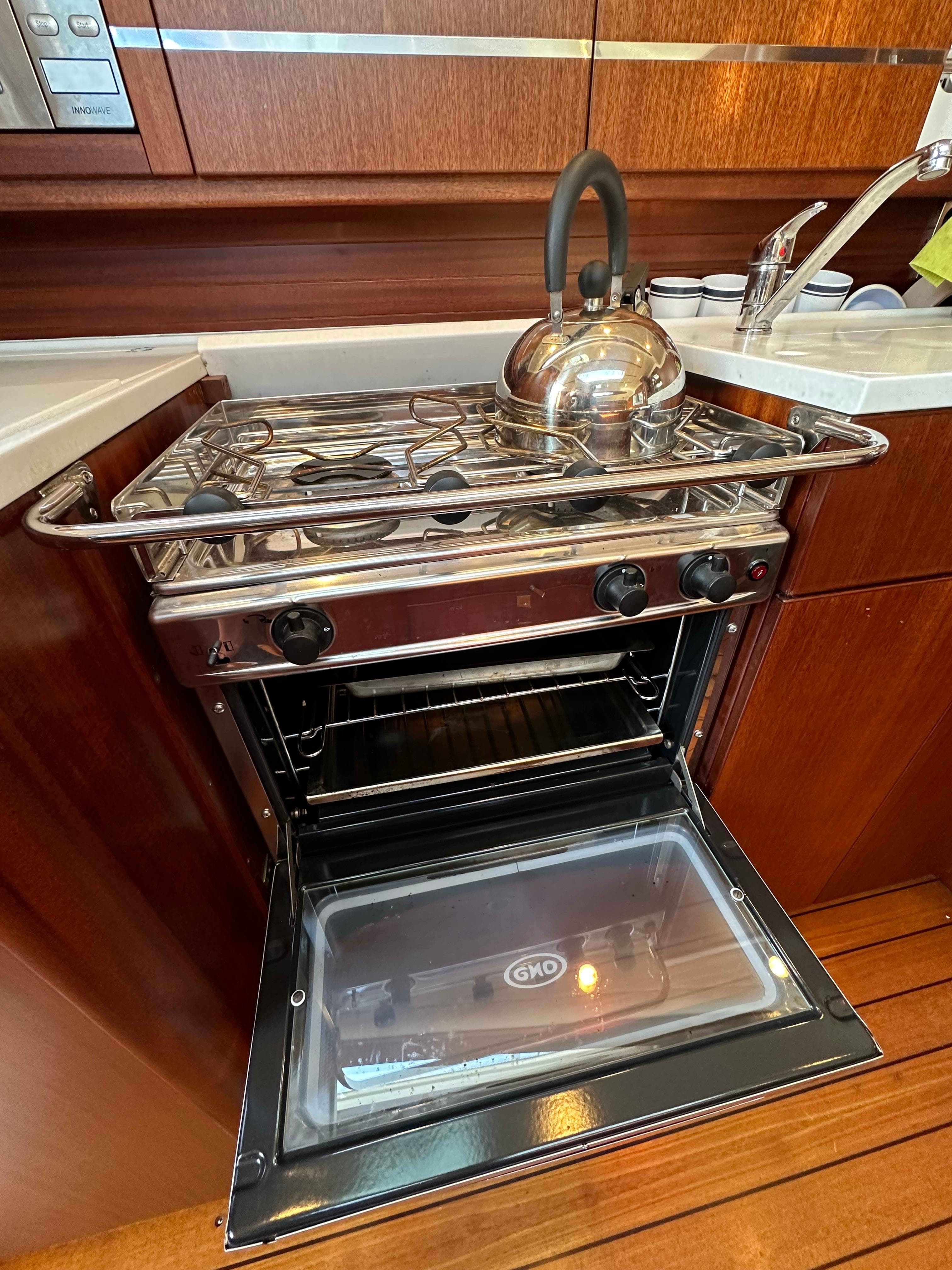 Stainless steel oven and stove in a 2007 Maxi 1300 yacht kitchen.